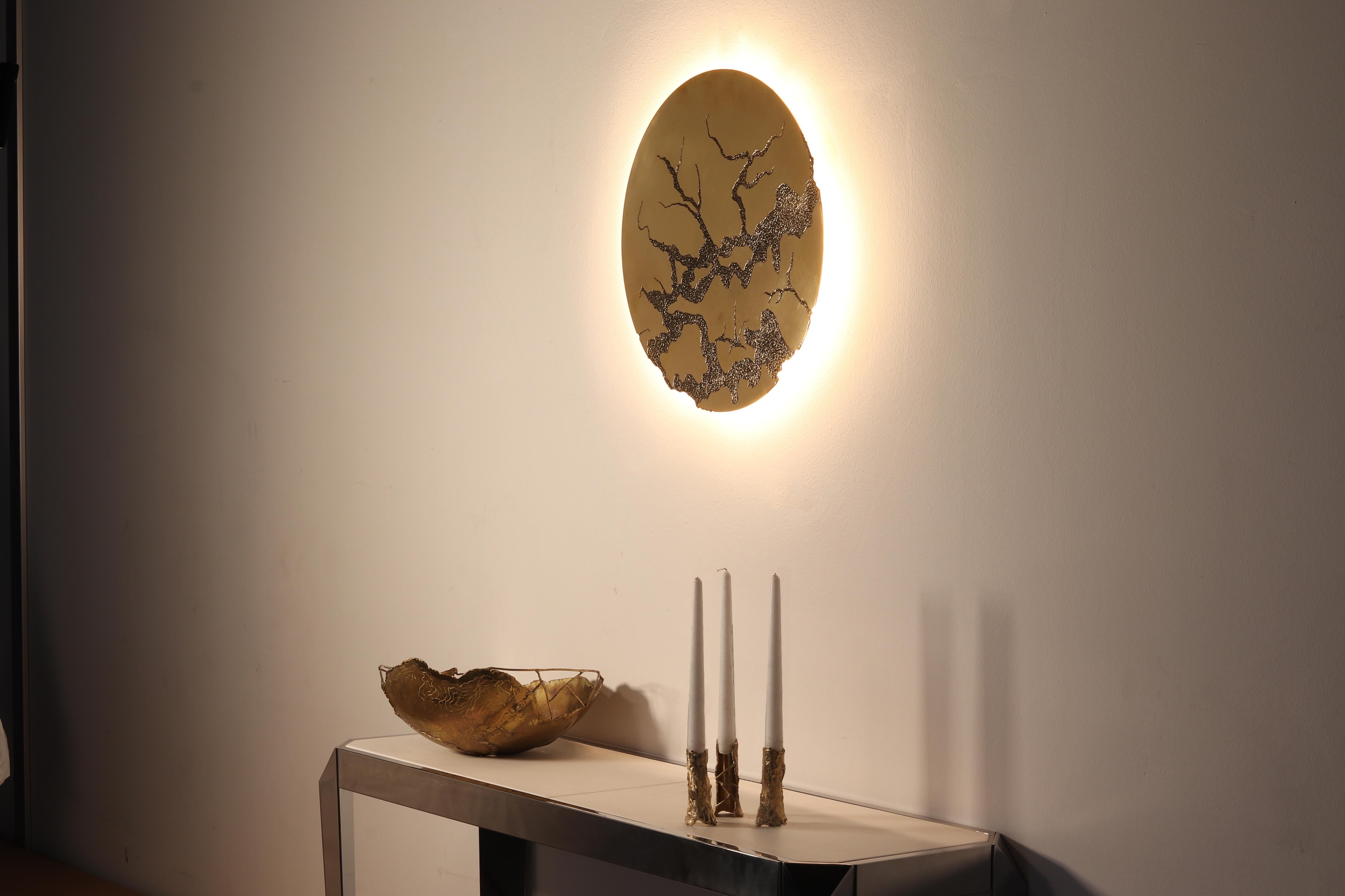Ice - hand-sculpted enlighted brass mirror by Samuel Costantini
Entirely hand-sculpted by the artist
Measure: diameter 50 cm
diameter 19,685 inches

Ice and Light brass mirror/ lamp
Nature tries to keep its balance despite everything. Winter