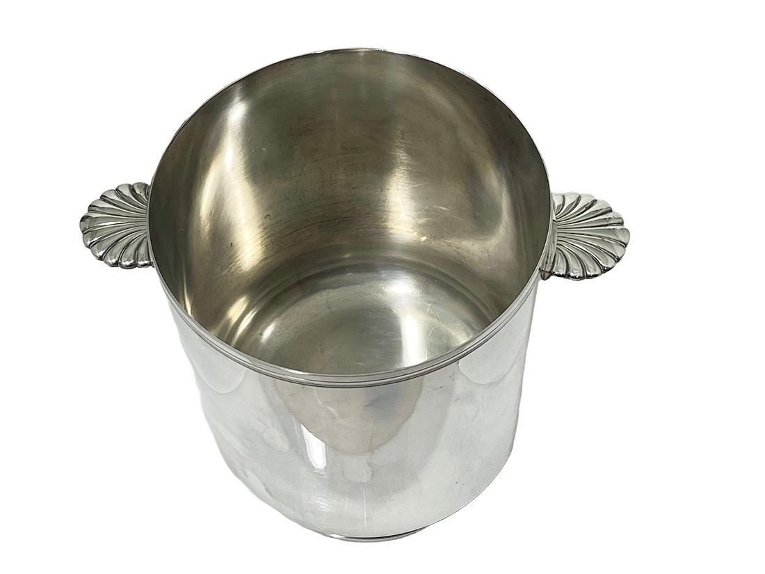 Ice or champagne bucket by Christofle silver plated, France, Mid-20th Century

A stunning champagne bucket in silver plate, a heavy quality piece by the famous French Orfevrerie Christofle of Paris.
This design has simple lines and footed base and
