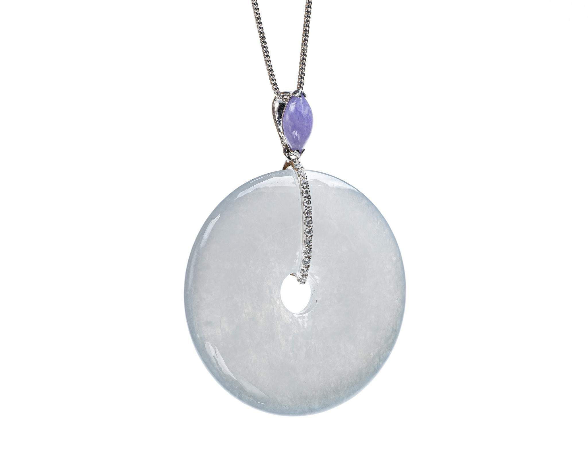 This is an all natural, untreated jadeite jade carved pi disc with lavender marquis pendant set on an 18K white gold bail.  The carved pi disc symbolizes peace and harmony.  

It measures 1.74 inches (44.3 mm) x 2.31 inches (58.8 mm) with thickness