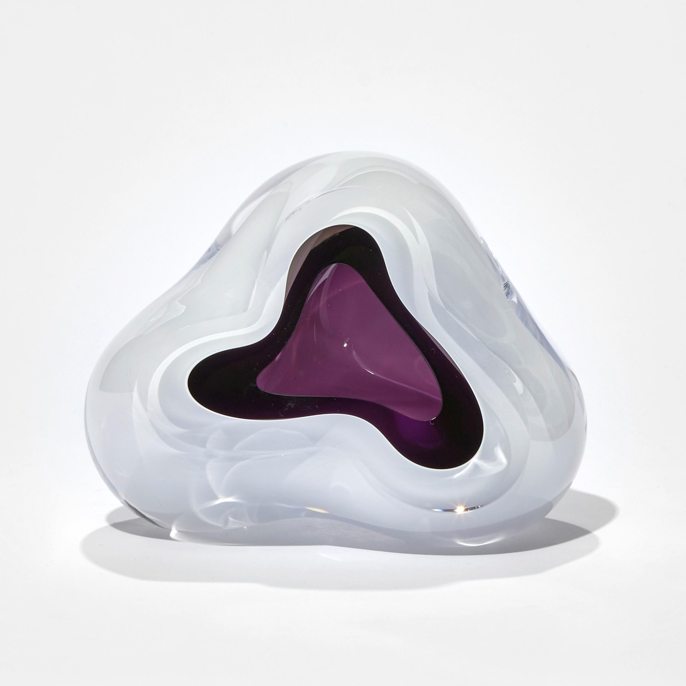 Ice Vug in Purple is a unique handblown sculpture by the British artist Samantha Donaldson. A charming ethereal sculpture with a glacier white exterior and rich purple cavernous interior. Taking inspiration from rock formations, geodes and the