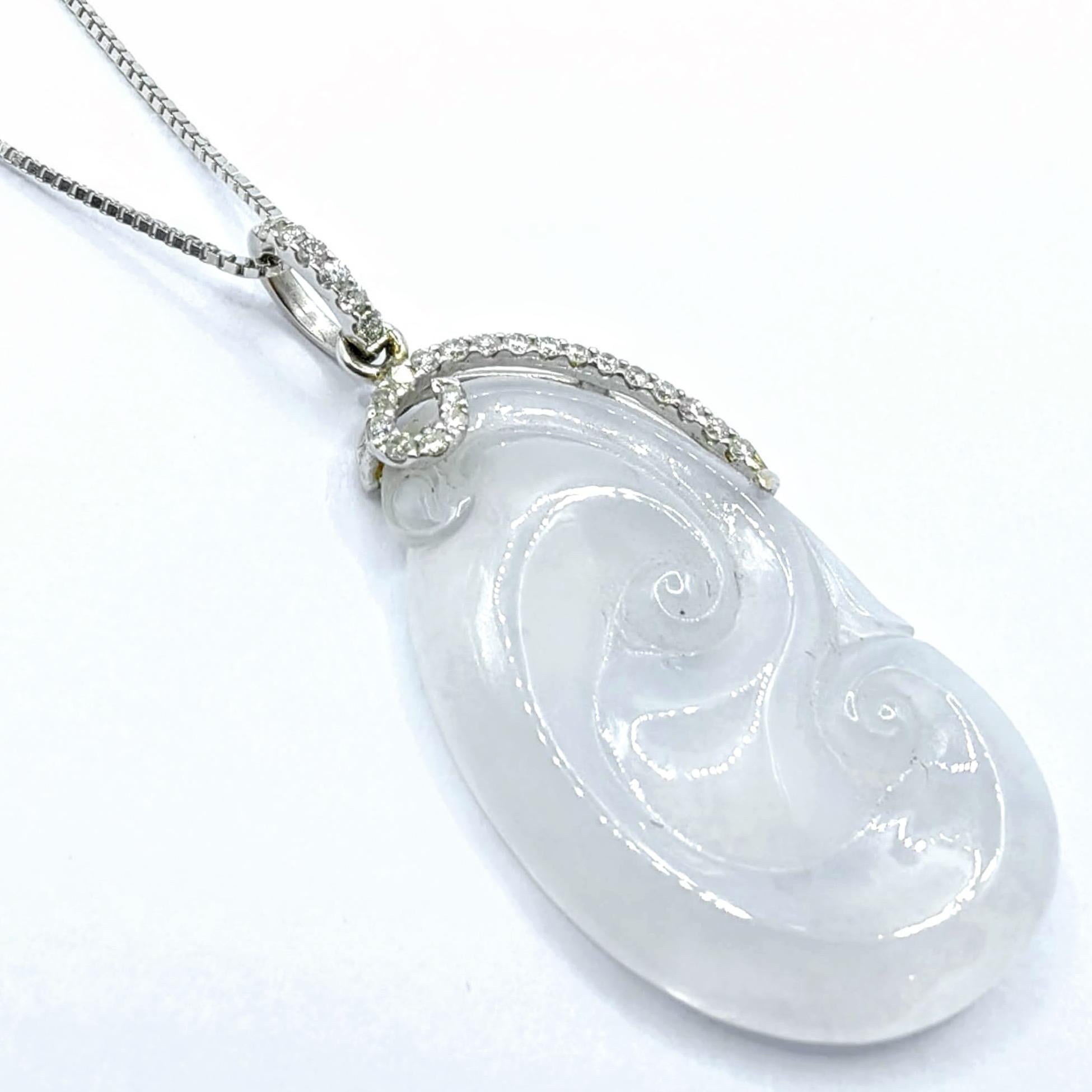 Discover the profound beauty of this exquisite Ice White Translucent Jadeite Jade Ruyi pendant, masterfully carved to showcase the stone's pristine translucency and natural luminescence. The traditional Ruyi (如意) shape, with its graceful flowing