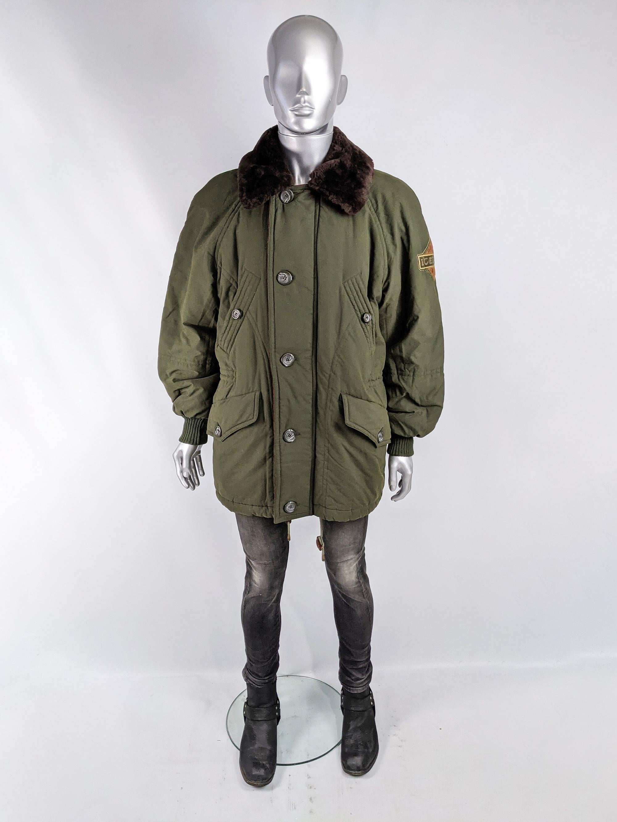 An excellent and rare vintage mens parka from the 90s by luxury Italian fashion house, Iceberg. In a military green, quilted fabric with raglan sleeves, inner drawstrings to pull in the waist for a more flattering cut, a faux fur collar, suede trim