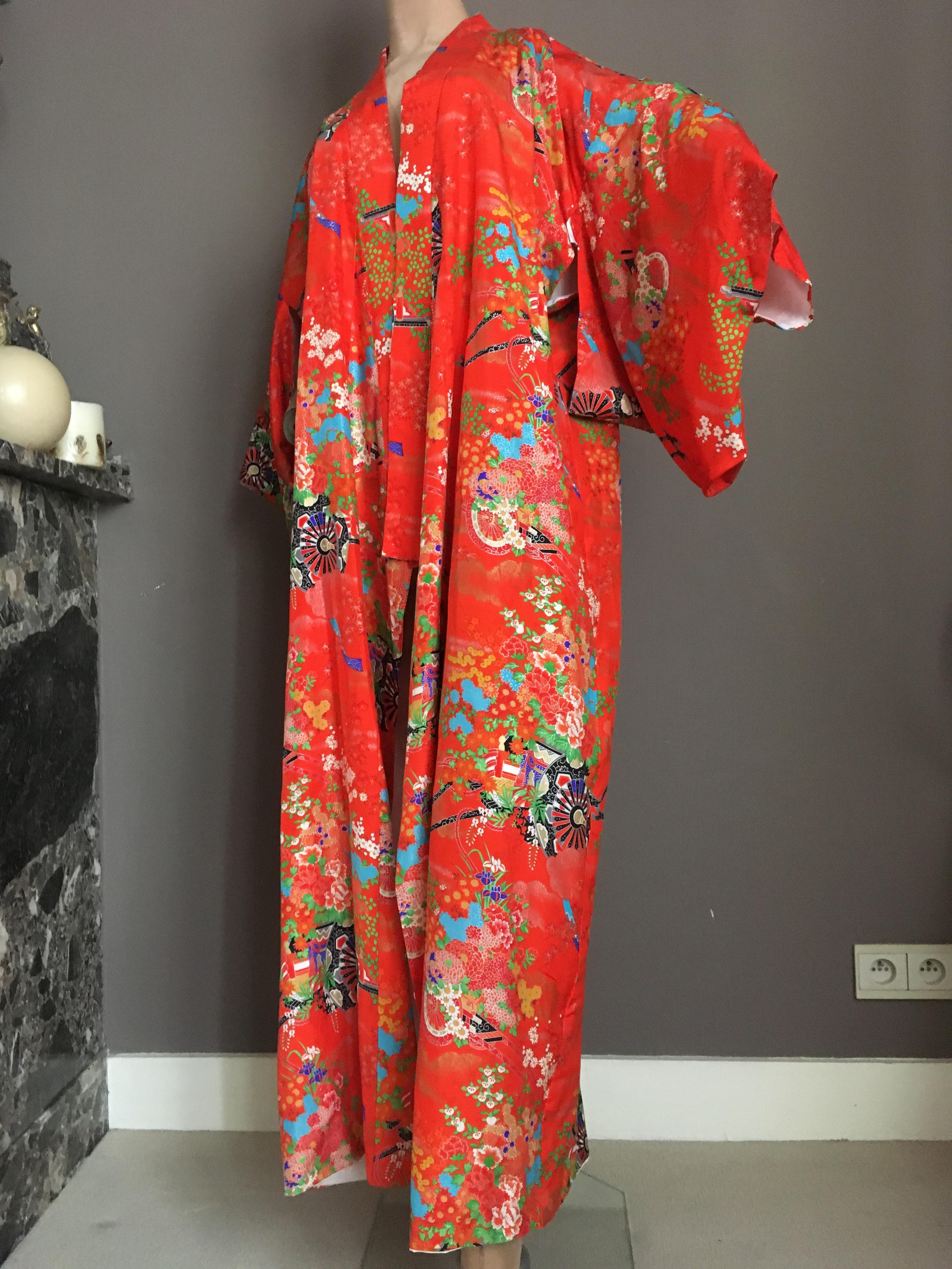 Ichiban Lounge Kimono made in japan,1960s soft, silk kimono robe with a print in orange,white,blue and black colors representation of a Japanese flower garden and symbols compiled into a naturally stylish Kimono to wear.

Kimonos are perfect for