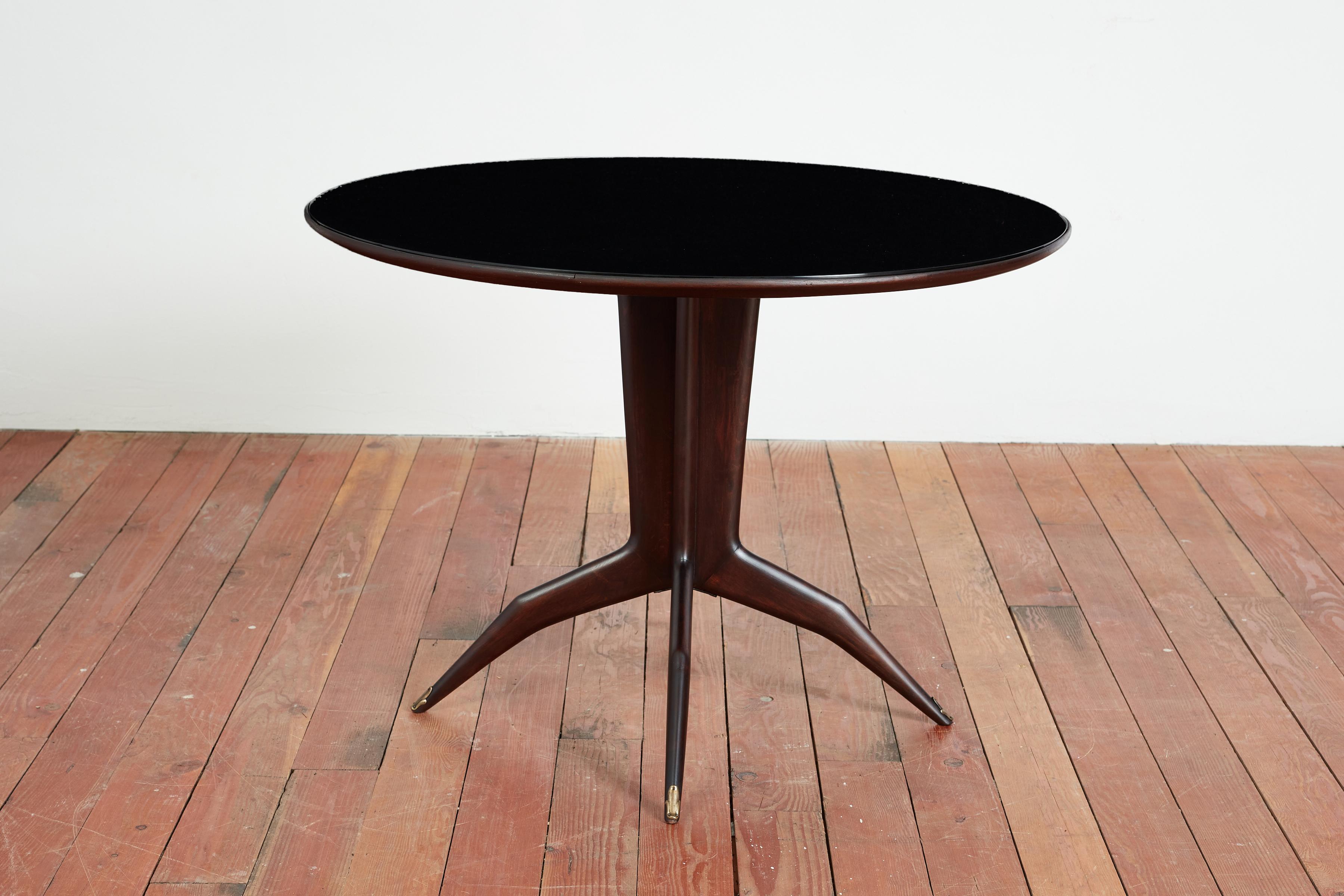 Sophisticated & sculptural center table attributed to Ico Parisi - Italy, 1950's 
Original deep mahogany base with brass feet and opaque black glass top 

Italy, 1950s 

