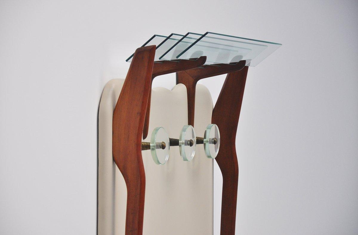 Superbly shaped coat stand attributed to Ico Parisi, made in Italy 1950. Very nice and refined coat stand made of walnut wooden legs, vinyl covered board, brass and glass coat hooks and glass shelves for hats on top. Very nice and unusual coat