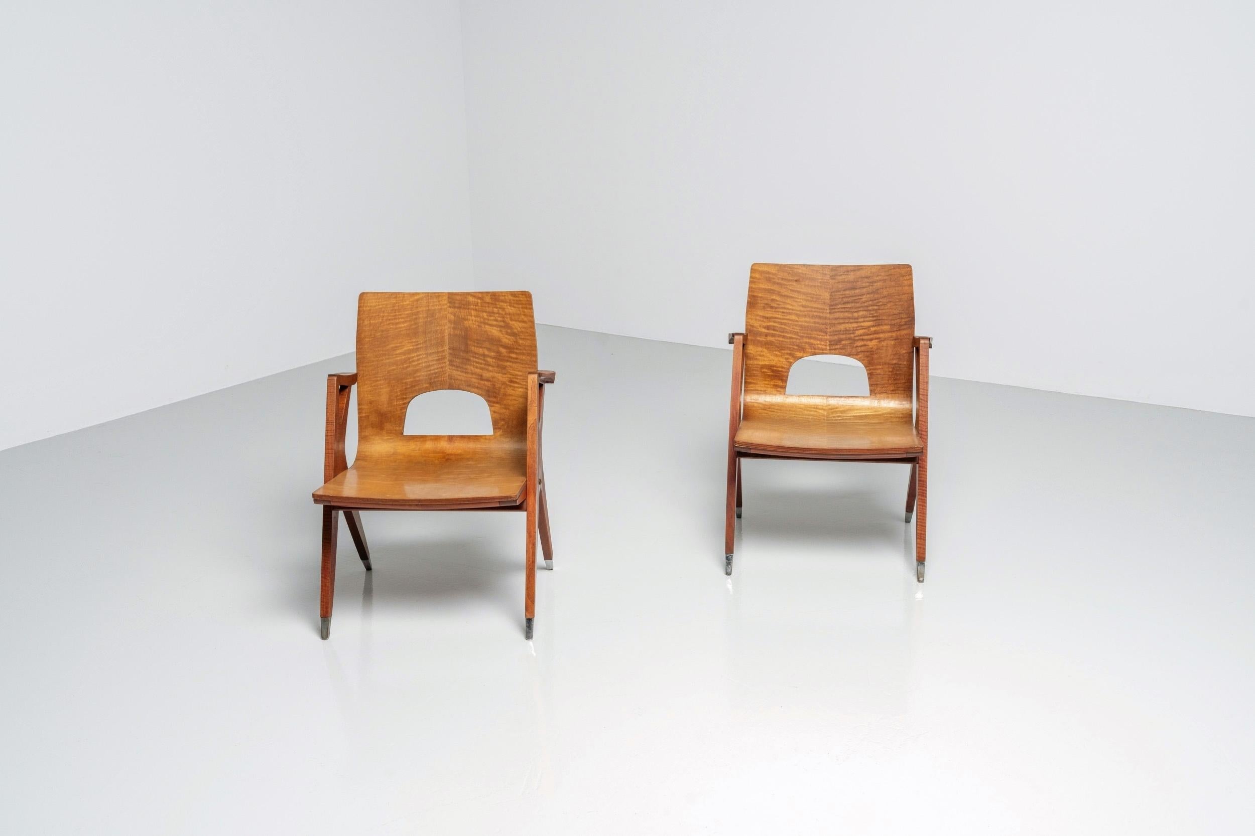 Beautiful shaped plywood lounge chairs attributed to a design by Ico Parisi pre MIM, Italy 1950. These chairs have a birch plywood seat with cherry backs. The two tone wood is very nice and often used in the designs by Parisi and gives the chairs an