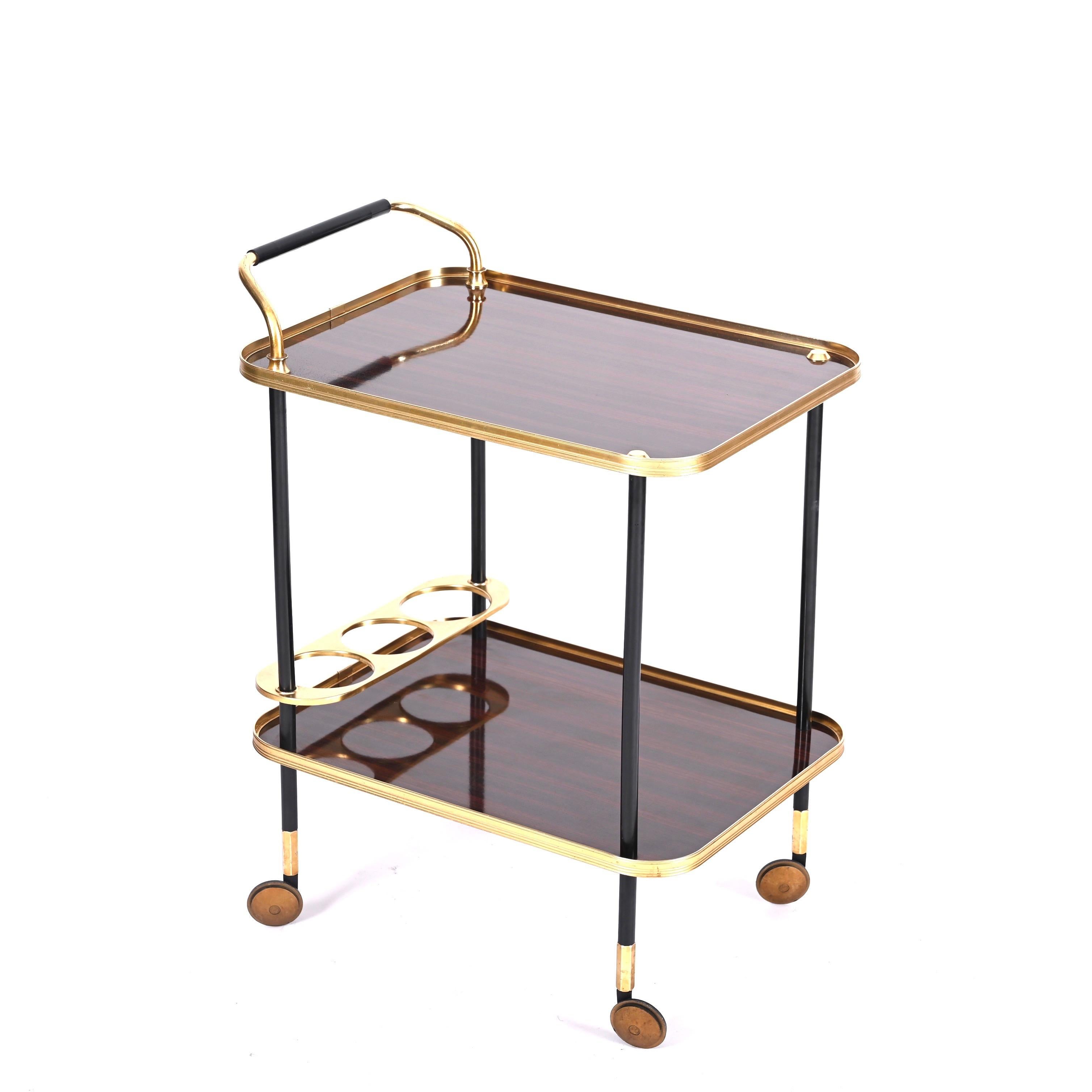 Fantastic midcentury serving cart, designed by Ico and Luisa Parisi for MB Italia in the 1960s. 

This stunning two level bar trolley features a structure made in golden metal and black laquered aluminium, the trays are made in a gorgeous formica