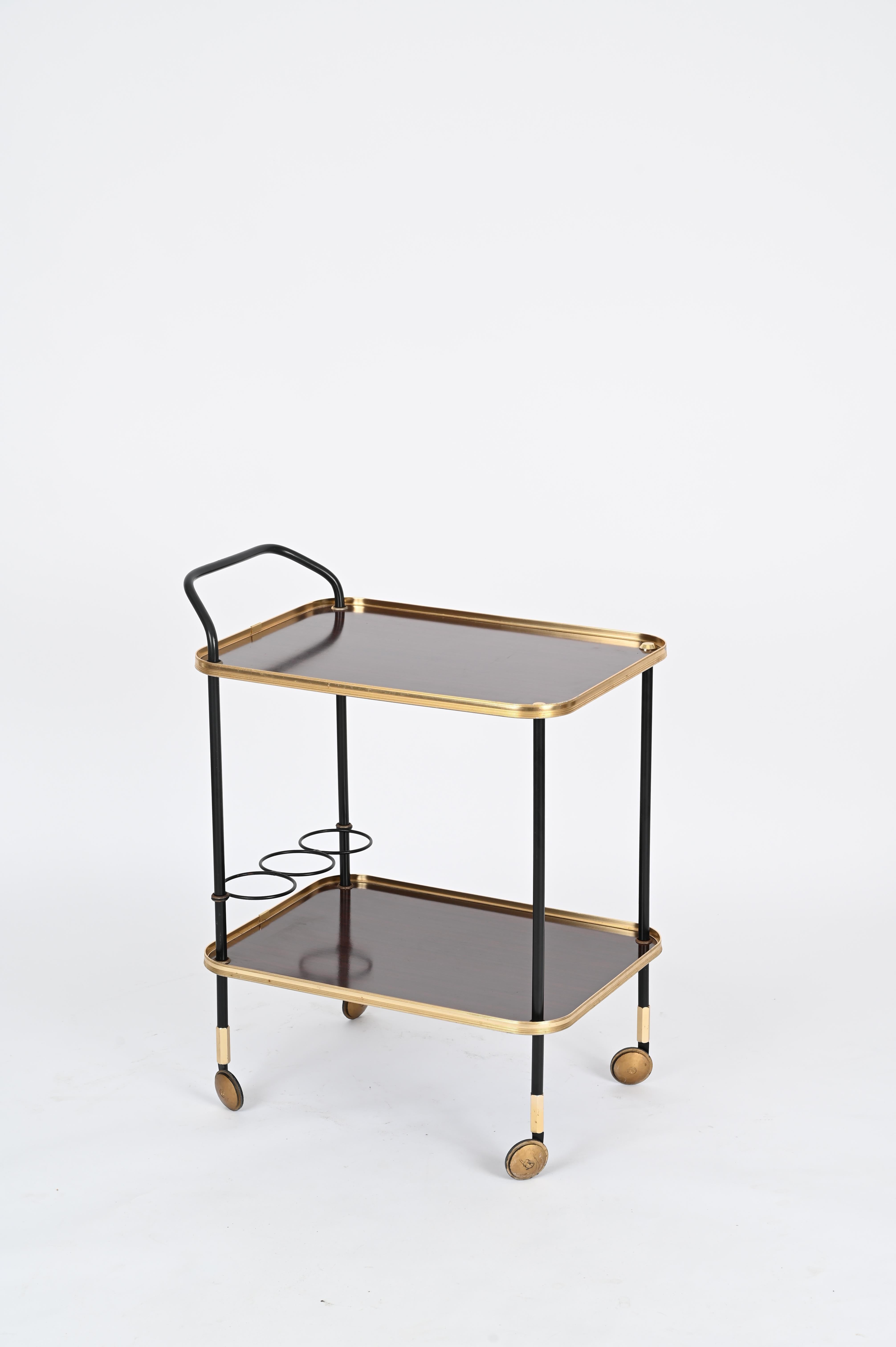 Stunning midcentury serving bar cart in gilt brass, laminated wood and enameled metal designed by Ico and Luisa Parisi for MB Italia in the 1960s. 

In fantastic condition, this wonderful two level bar trolley features a structure made in golden