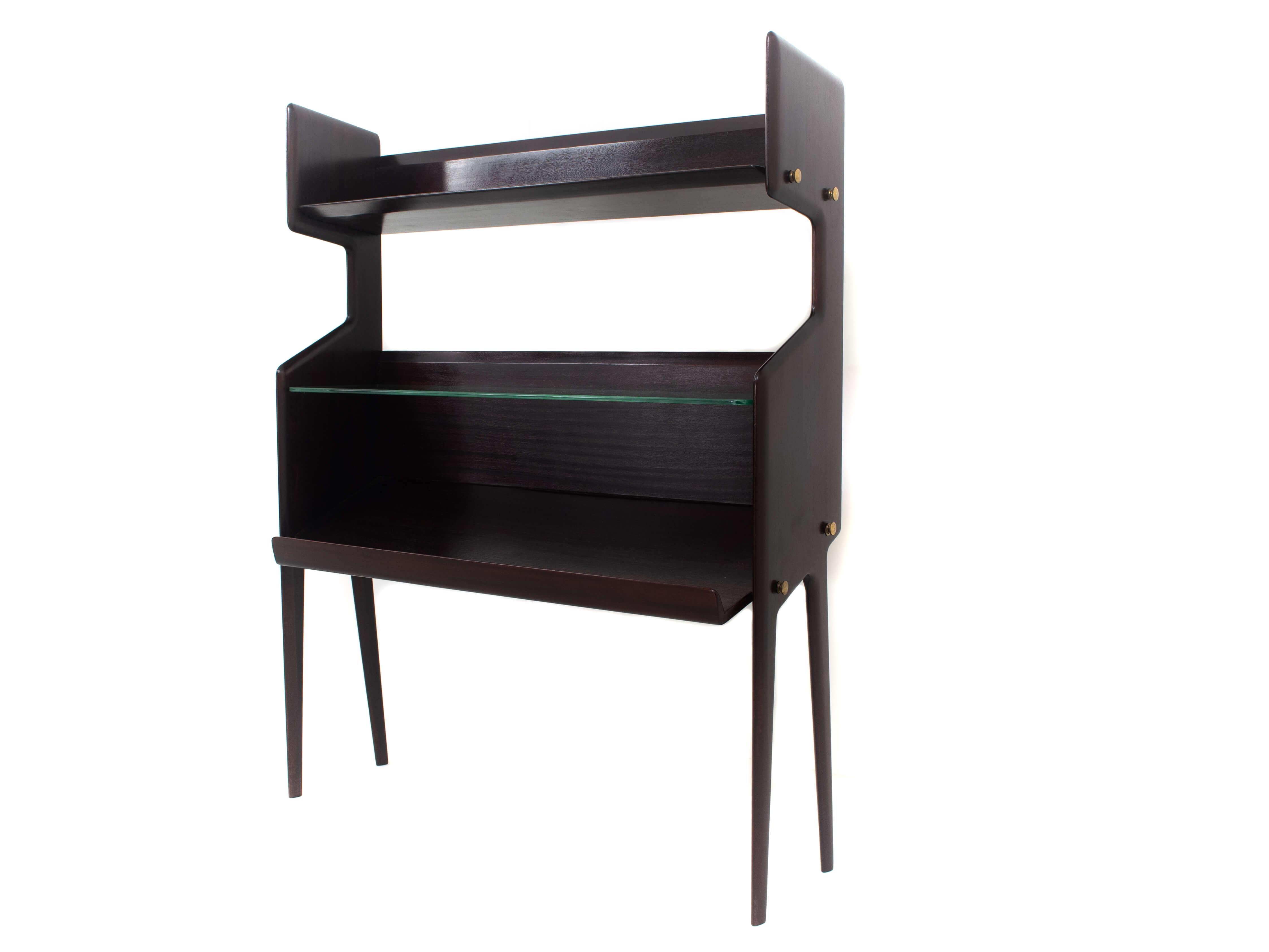 Charming Italian Modern Ico Parisi bookcase model 459 in Mahogany Veneer. This bookcase is manufactured by Angelo de Baggis Cantu in Italy in 1955/1956. It has two solid wood carved sides supporting the elegant legs that are typical for Ico Parisi