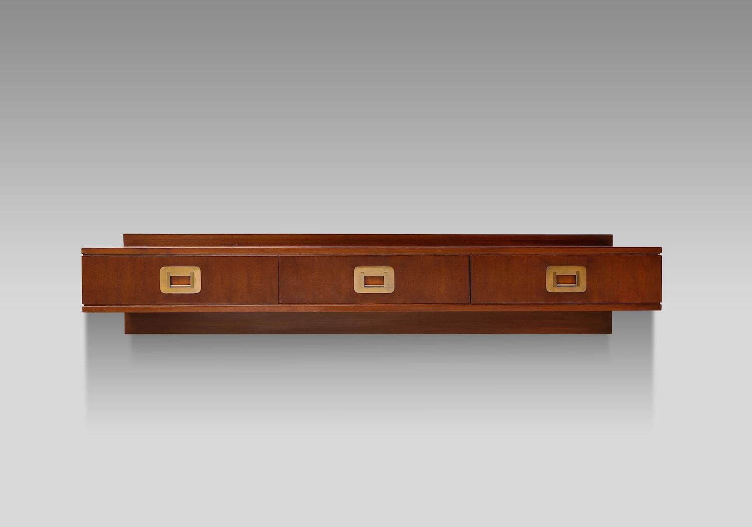 Custom wall-mounted console by Ico Parisi. Sleek wall-mounted console table of mahogany with 3 drawers and great brass hardware. From a custom commission, produced by Brugnoli, Cantú. This piece has been authenticated by the Archivio Ico Parisi.