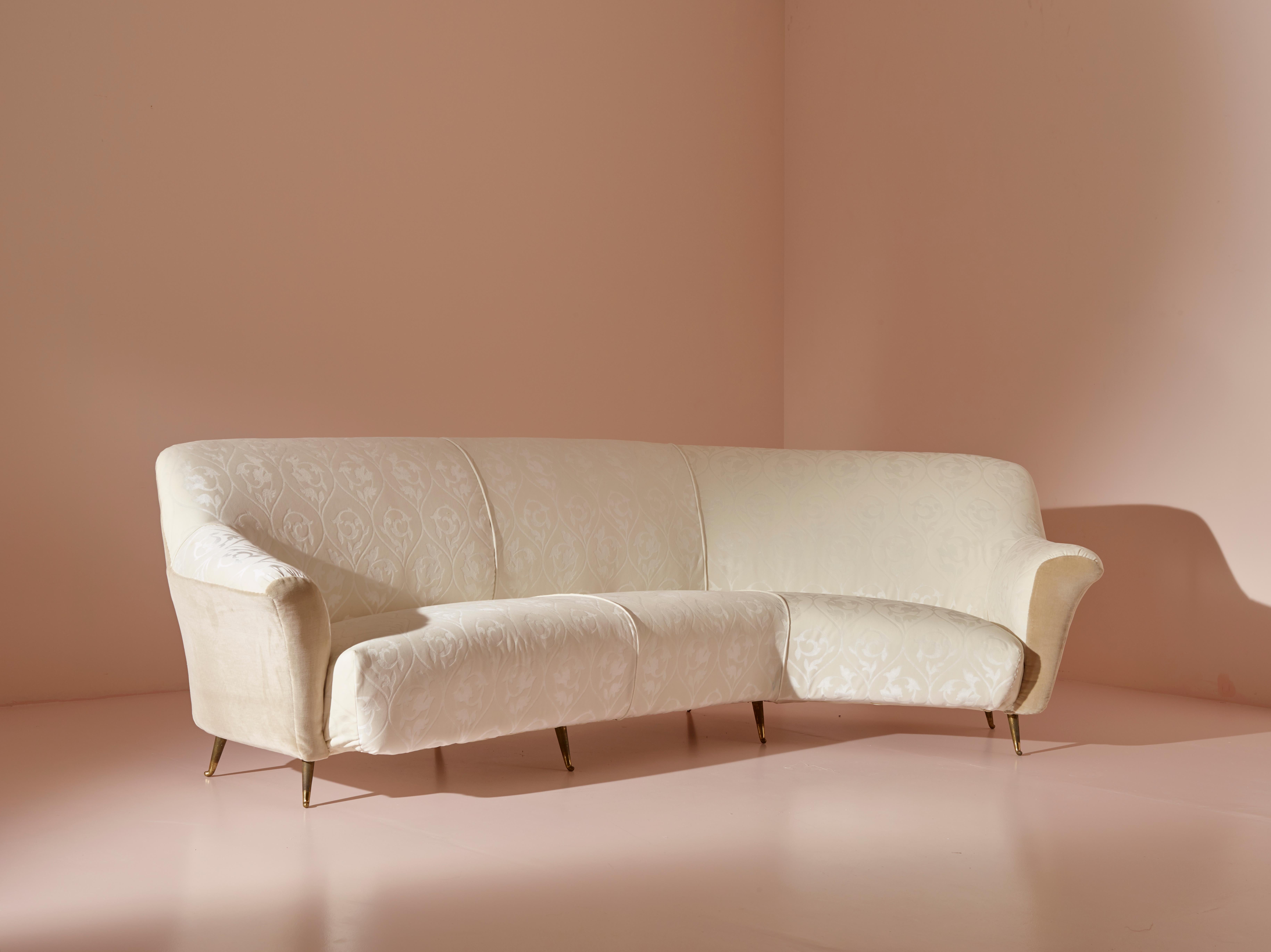 Curved fabric sofa with brass legs, designed by Ico Parisi, manufactured by Isa Bergamo.

This sofa, designed by Ico Parisi, epitomizes the finest stylistic research of the 1950s. Its enveloping lines and comfortable seating are enhanced by an