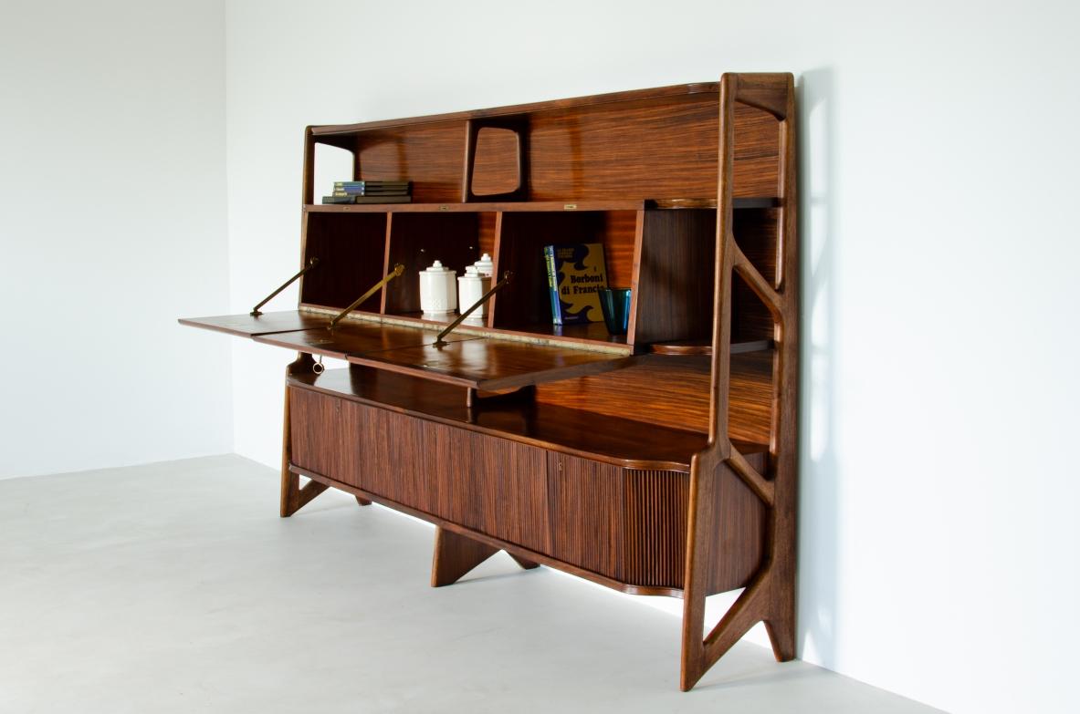 Ico Parisi, early 1950's cabinet supported by elegant uprights in walnut with three central flap compartments and ribbed wood doors at the base with shelves and drawers.

Bibl .: I. De Guttry - M.P. Maino, The Italian furniture of the 1940s and