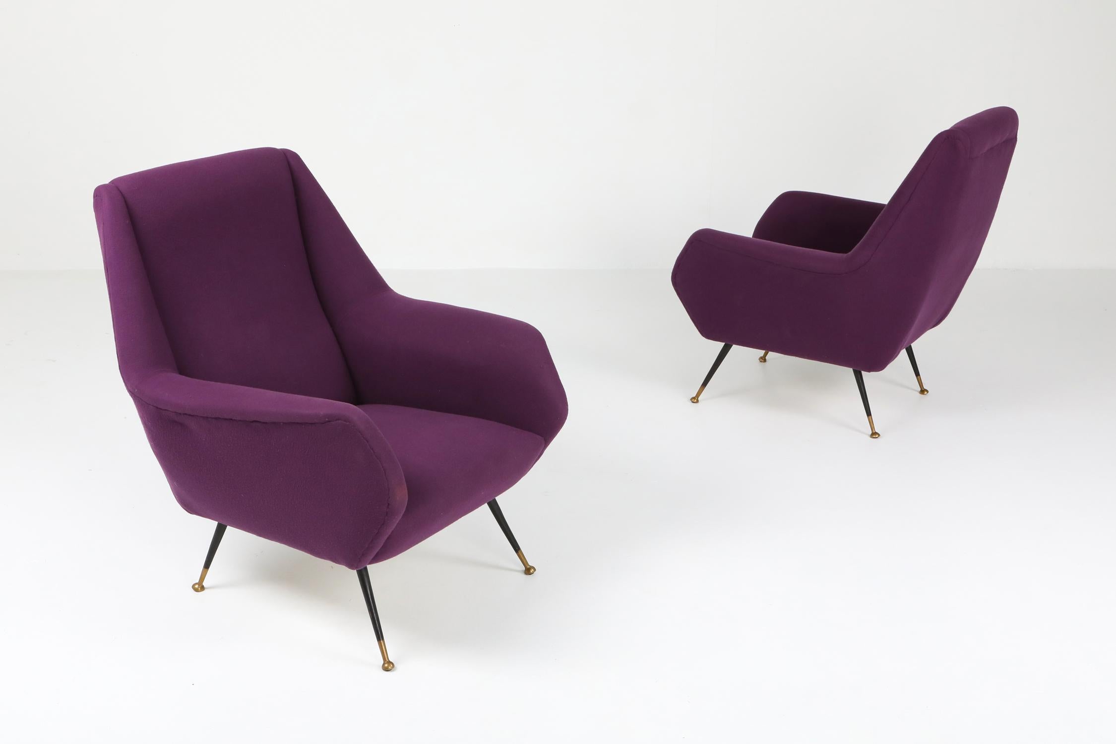 Italian pair of arm chairs, by Ico Parisi, purple fabric.

Black metal legs which end on brass round feet.
1950s Italian chic chairs which would fit well in an eclectic Hollywood Regency inspired interior.
    