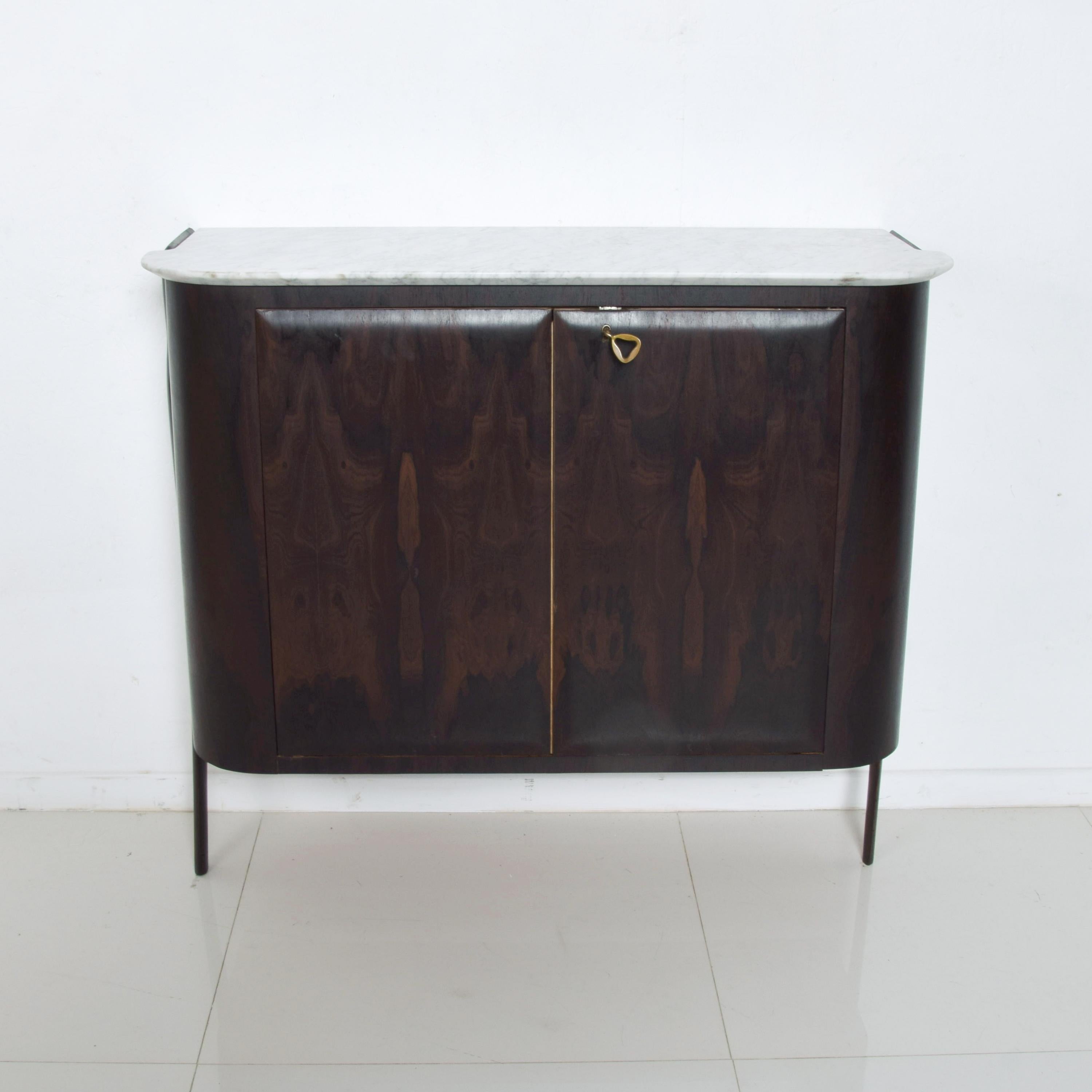 Ico Parisi elegant Italian marble entry console modern bar cabinet in rosewood Ziricote wood retains original key lock pull, circa 1950s, Italy
Has very clever key handle pull that serves as a lock. New marble top. Finish refreshed.
Double door