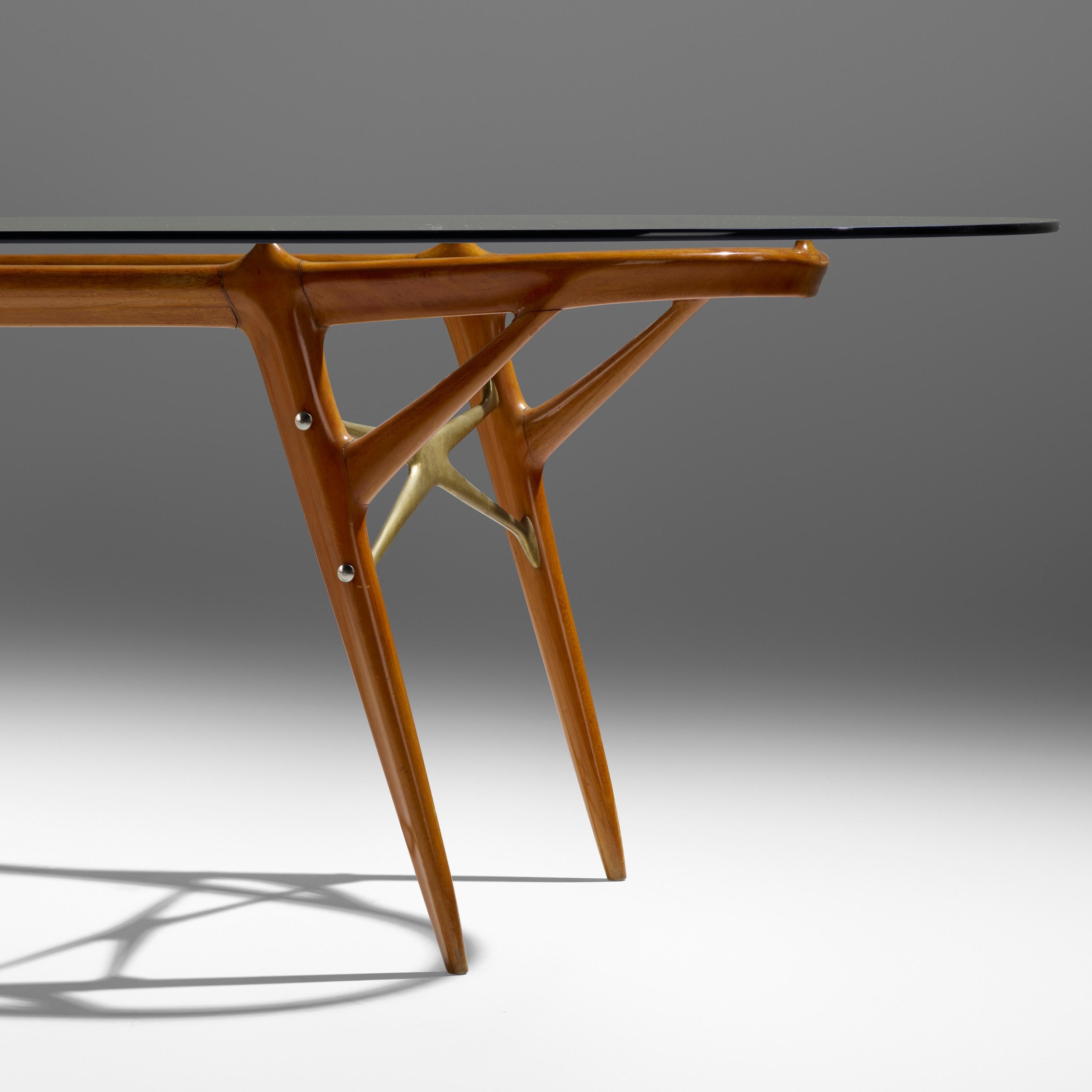 Ico Parisi (1916 - 1996) and Luisa Parisi (1914 - 1990)

A stunning and highly unusual dining table by visionary Italian designers Ico and Luisa Parisi, in blond elm with significant bronze detailing and a glass top. Four tapering, Y-shaped legs,