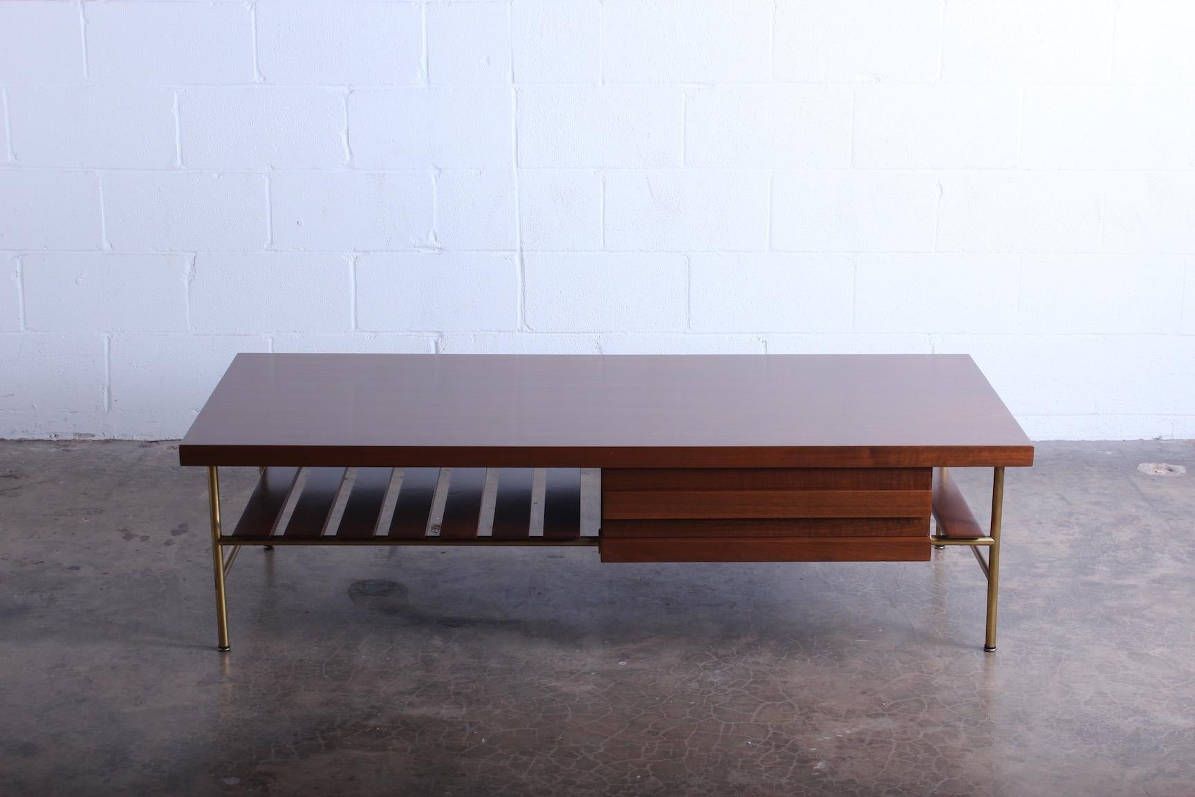A rare walnut and brass coffee table (no. 2185) designed by Ico Parisi for Singer & Sons.