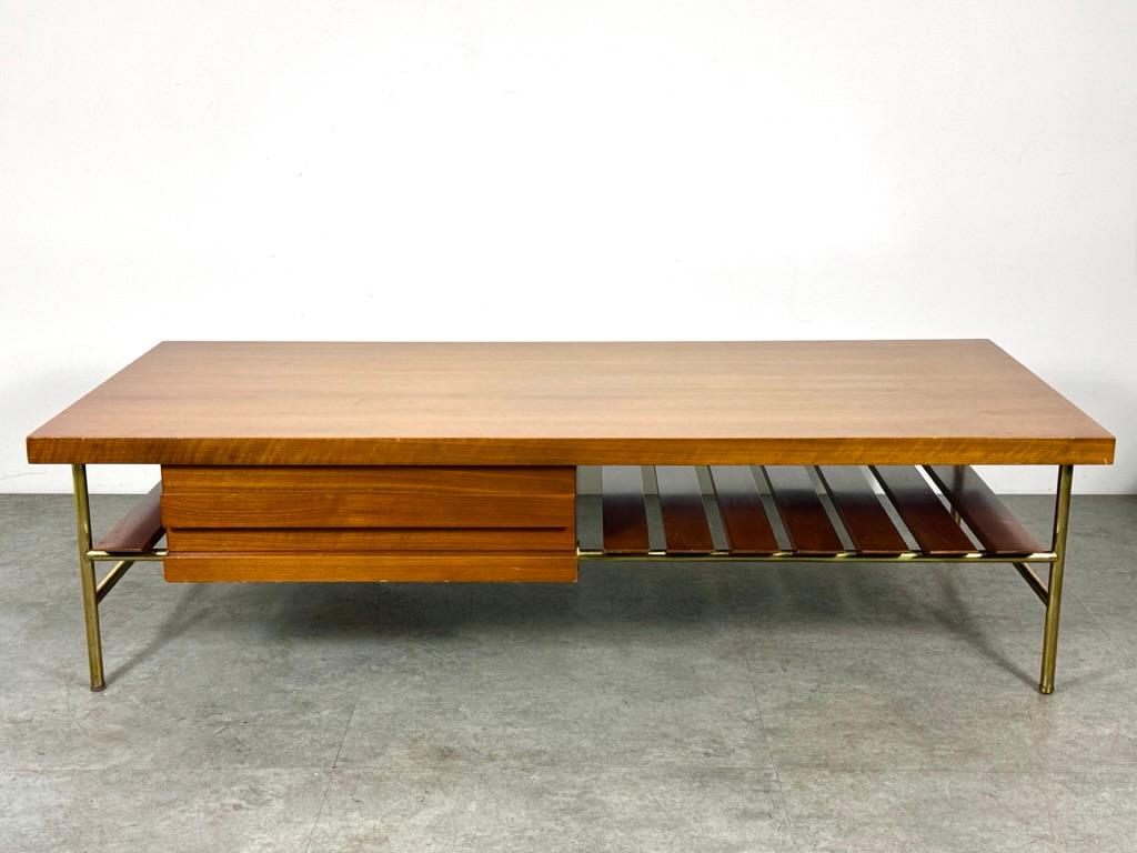 A rare coffee table designed by Luigi and Ico Parisi for M Singer & Sons
Model 2185 circa 1960s

Walnut surface with single side drawer and lower slat shelf
Brass frame legs and fittings
Original finish with age and use related wear

61 inch