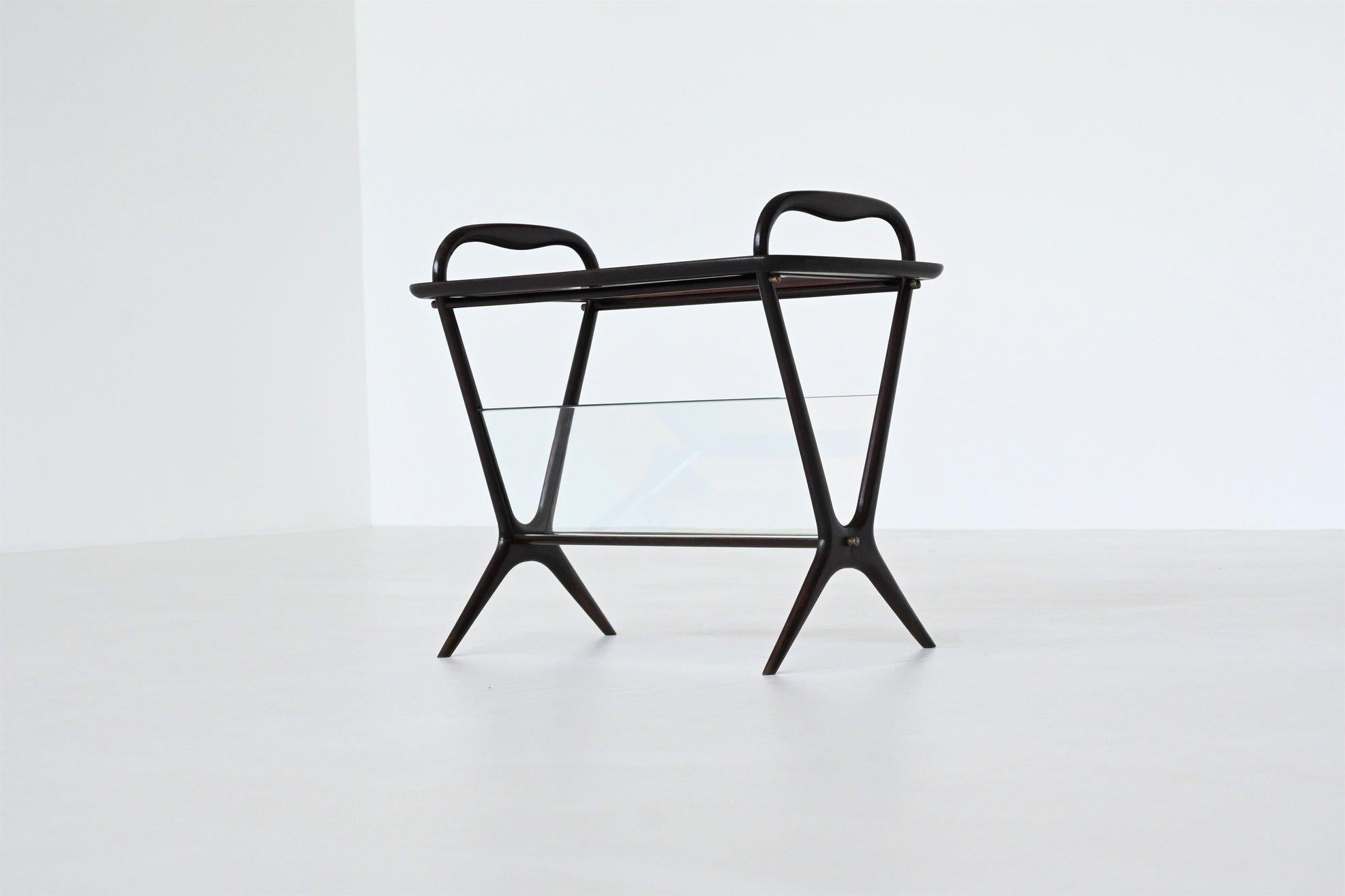 Beautiful shaped magazine rack or tray table model 221 designed by Ico Parisi for De Baggis, Italy 1956. This highly refined table has a mahogany base that supports two inclined glass shelves and a removable tray with wooden frame and inlayed glass