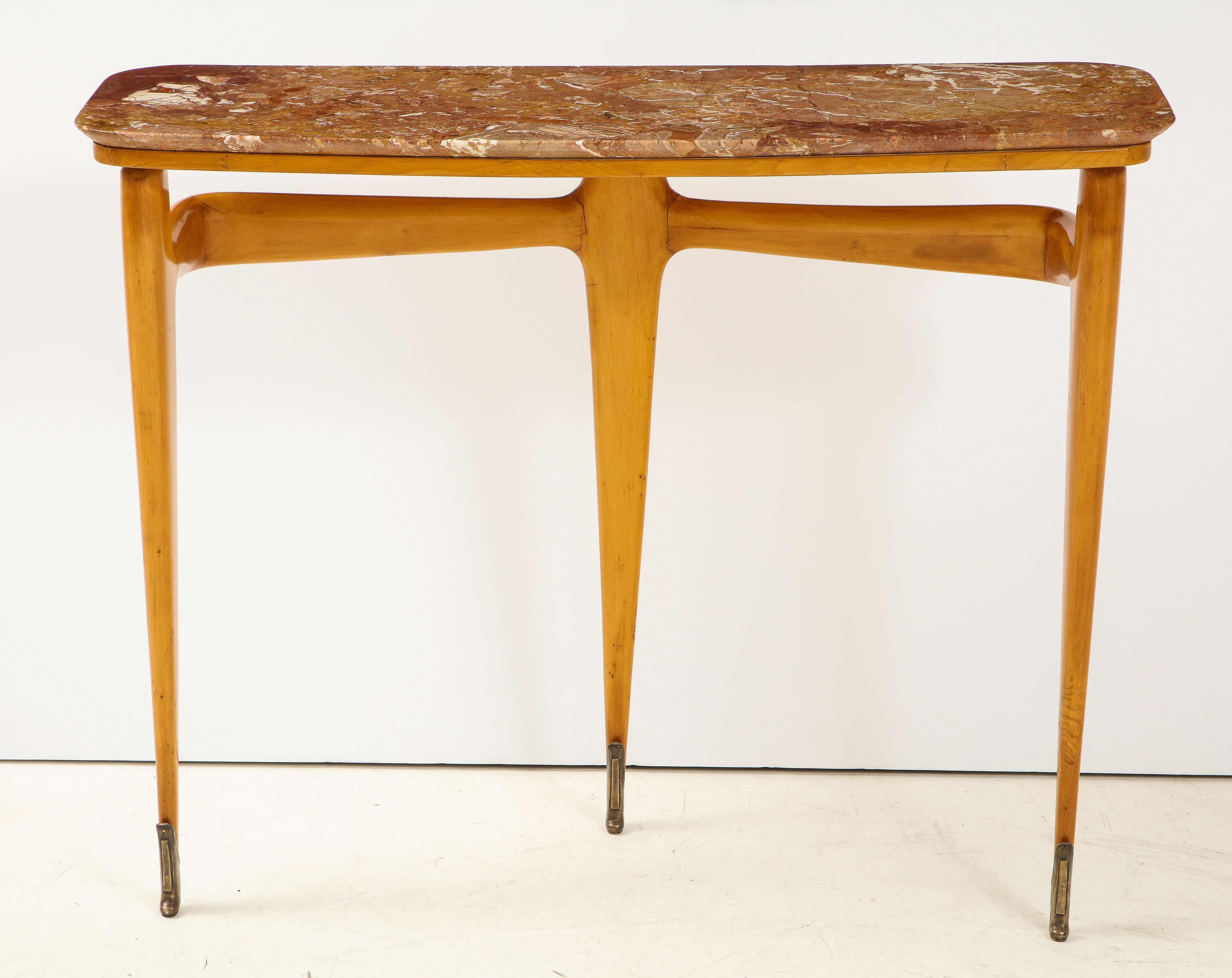 Beautifully shaped maple wood console table with Breccia marble top supported by tripod stunning tapered legs ending in elegant brass sabot. The three legs joined on the back side by a horizontal shaped wood stretcher. The wood warm and golden