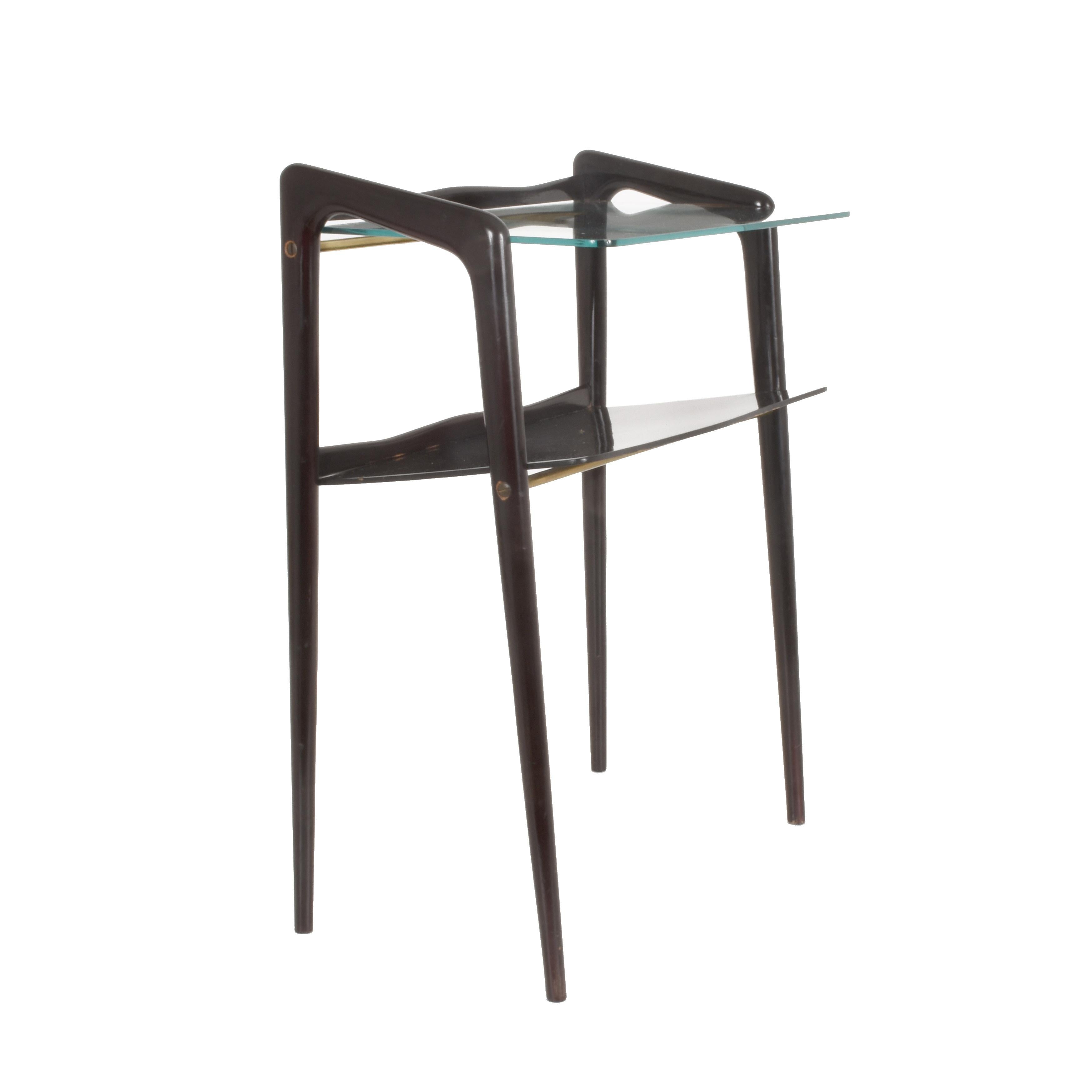 Wonderful midcentury ebonized wood and glass magazine table. This incredible item is attributed to Ico Parisi, in Italy during the 1940s. 

The interior elegance of this surprising piece, the legs and the small drawer is in ebonized wood. The legs