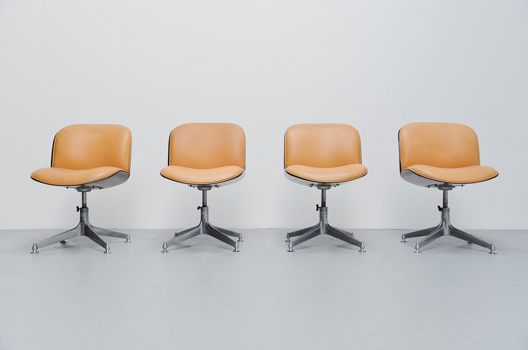 Nice set of 4 office swivel chairs from the Terni series designed by Ico E Louisa Parisi and manufactured by MIM Roma, Italy 1958. These chairs have an aluminium star shaped base and the shells are made of walnut veneer. These chairs have a natural