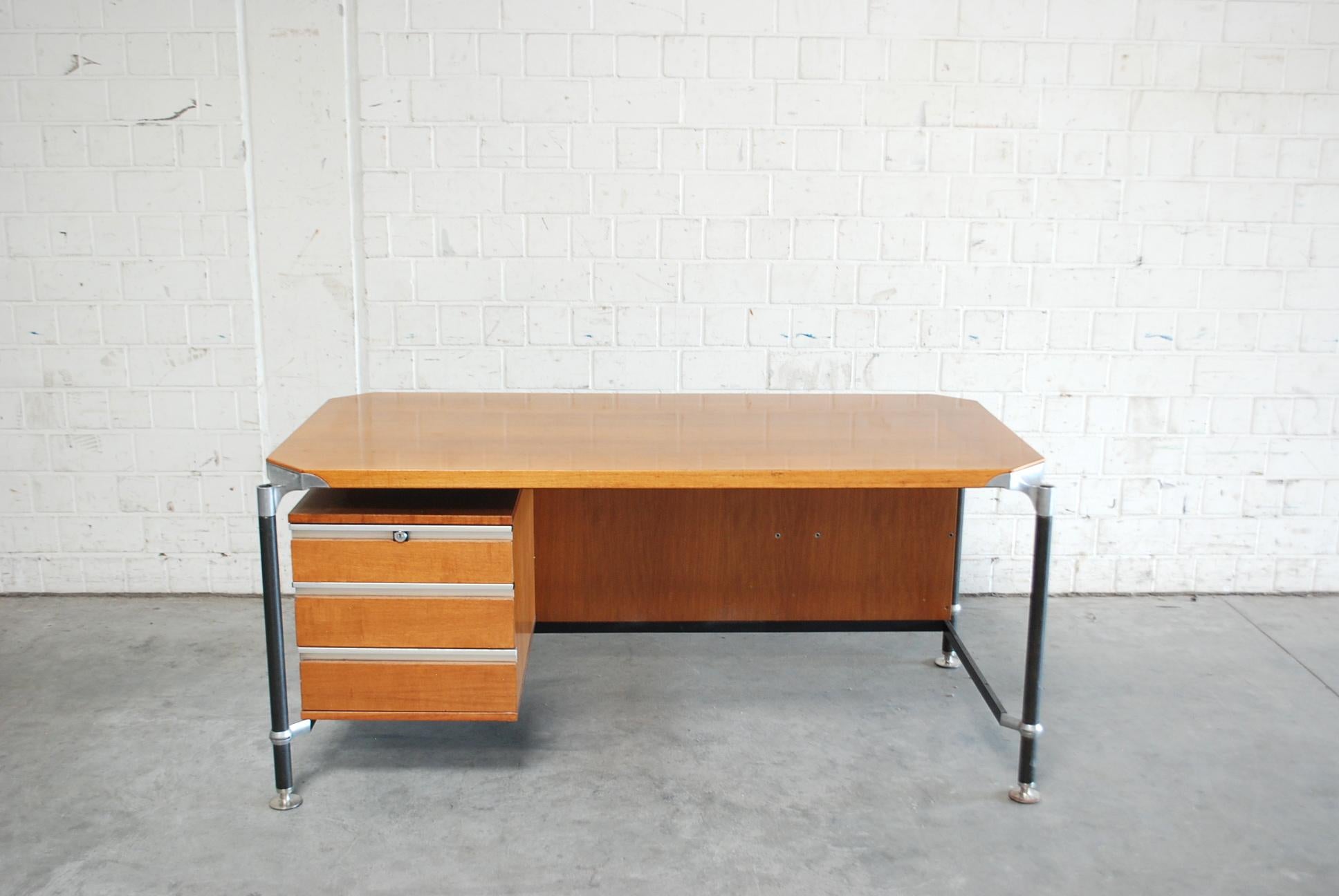 This office desk was designed by Ico Parisi for MIM Italy.
It has a walnut veneer and a drawer on the left side. 
The keys to the drawer are lost.
With aluminium details and steel feet.
It's in original used condition.
 