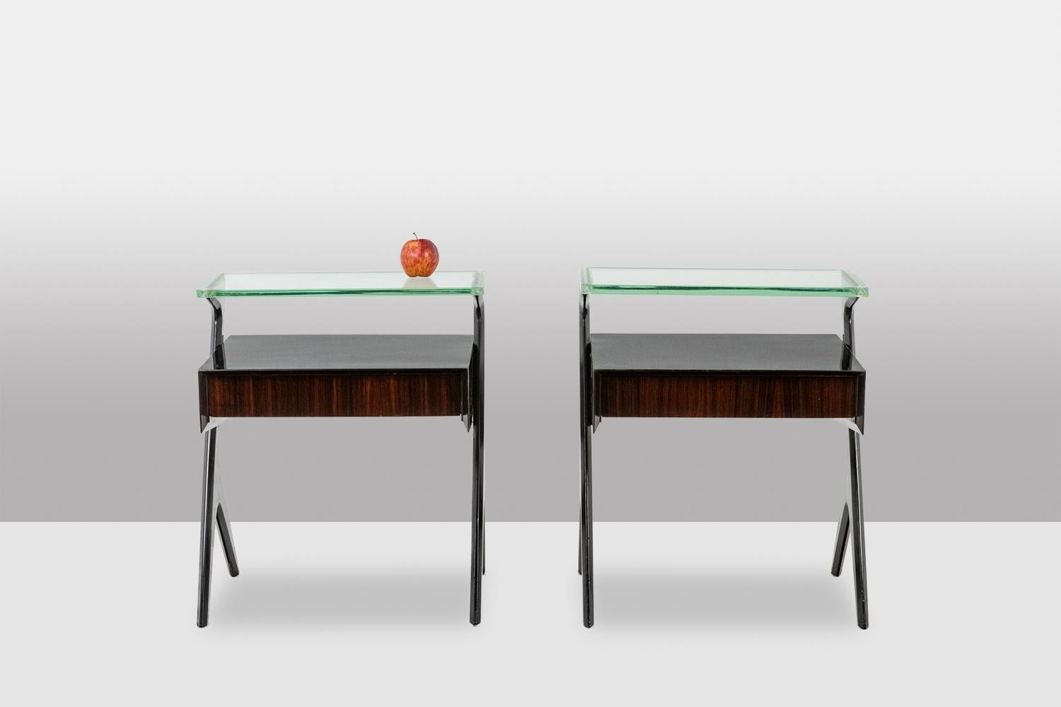 Ico Parisi
Pair of bedside tables or end tables. Black wooden base, laminated wood drawer unit and black lacquered top, thick glass top (2 cm) with engraved frieze decoration.
Italian craftsmanship from the 1950s-60s.
Dimensions: H 24.7 in x W 21.3