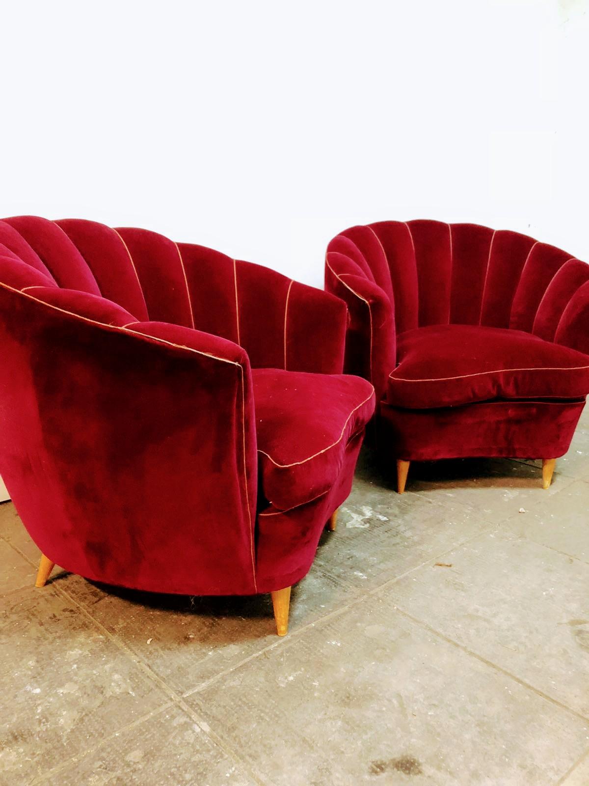Ico Parisi pairs armchairs, Mid-Century Modern, Italian design, red velvet original and wooden feet. The soft and enveloping shape reminds the shell.