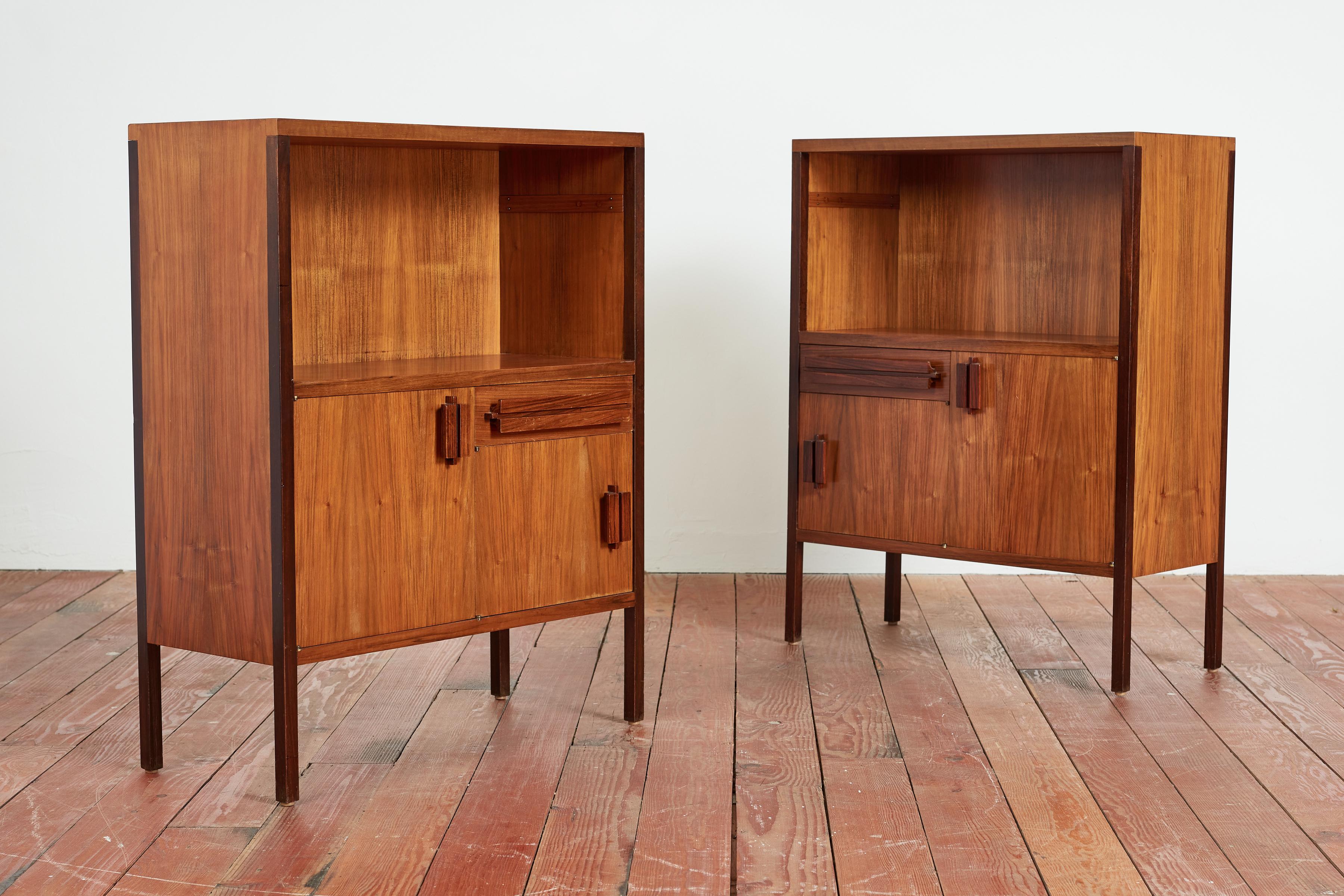 Pair of Wooden bedside tables Positano model. Designed by Ico Parisi for manifattura MIM Roma. 
Italy, 1950s
Beautiful patina to wood.
Each bedside table has a shelf, two open compartments with hinged doors and a drawer for storage. 
Original dark