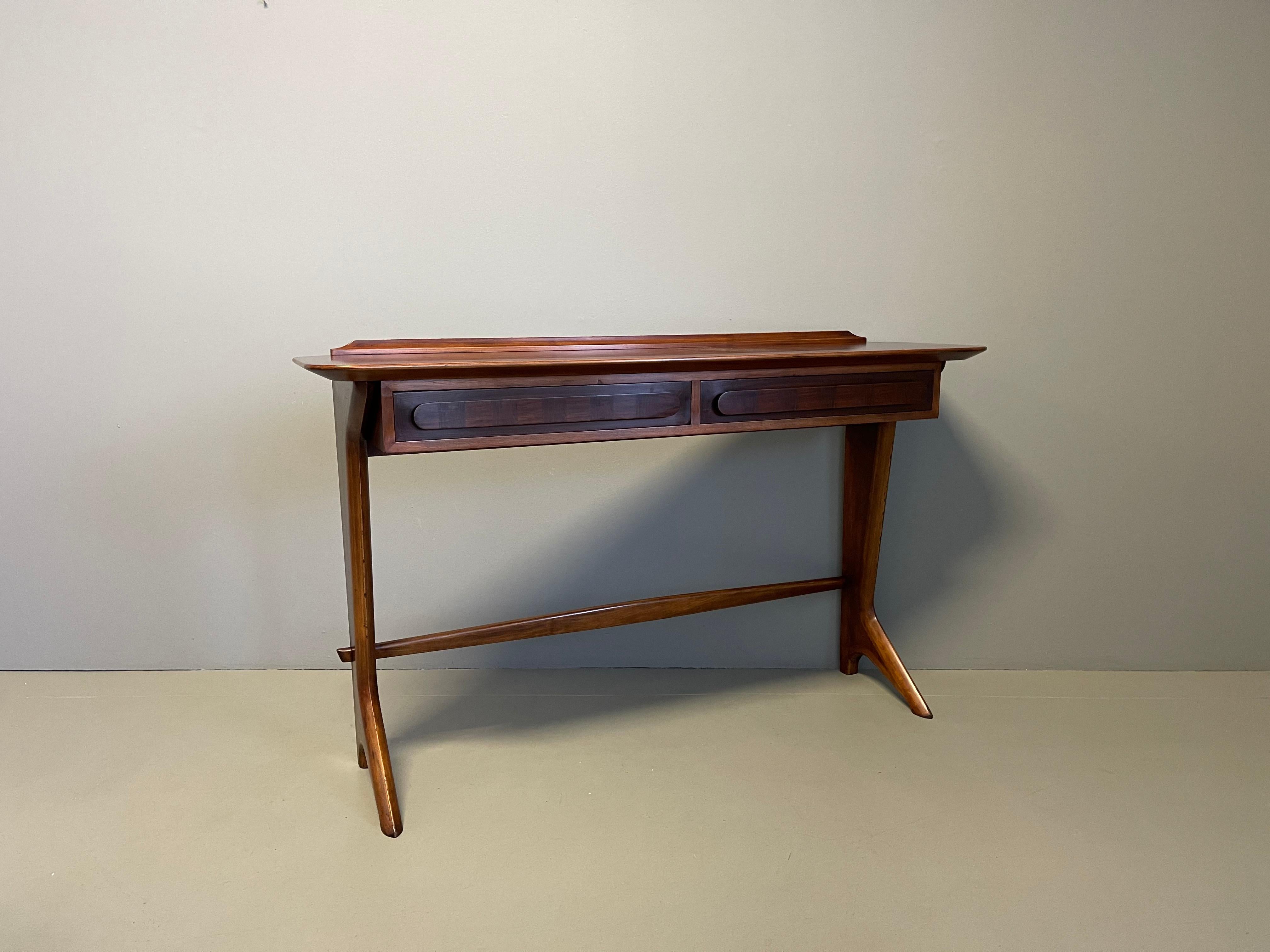 Rare and important Italian Mid-Century Modern console or sofa table in Italian walnut by Ico Parisi. Sculptural form with 2 drawers and herringbone inlay to top and throughout. 2 pieces are known to have been made. A daring piece of architecture and