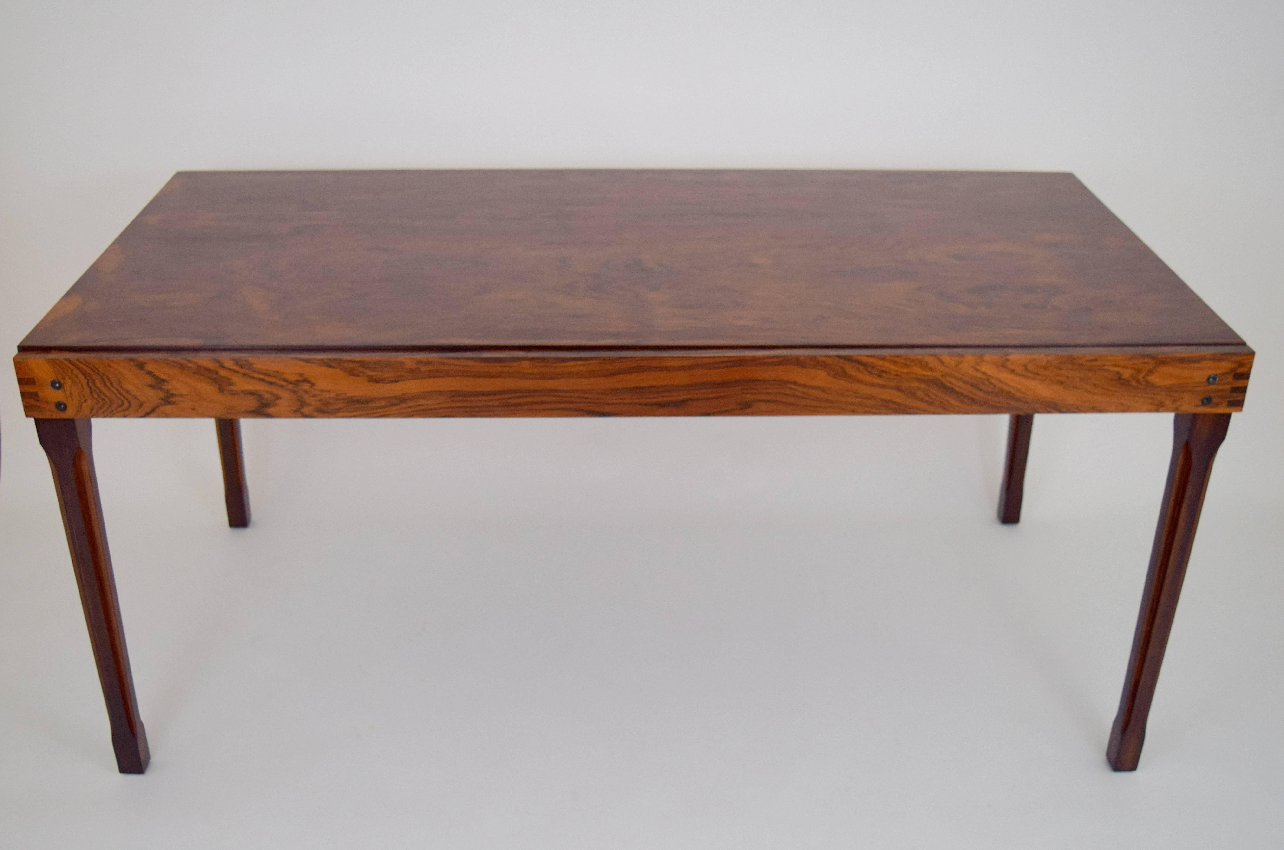Rare Ico Parisi for M.I.M. rosewood expanding table. Sliding rectangular top reveals self stowed rotating extending leaf with delicate rosewood pull. Fluted leg details elegantly offset by apron finger joint corners. Lovely grain throughout, with