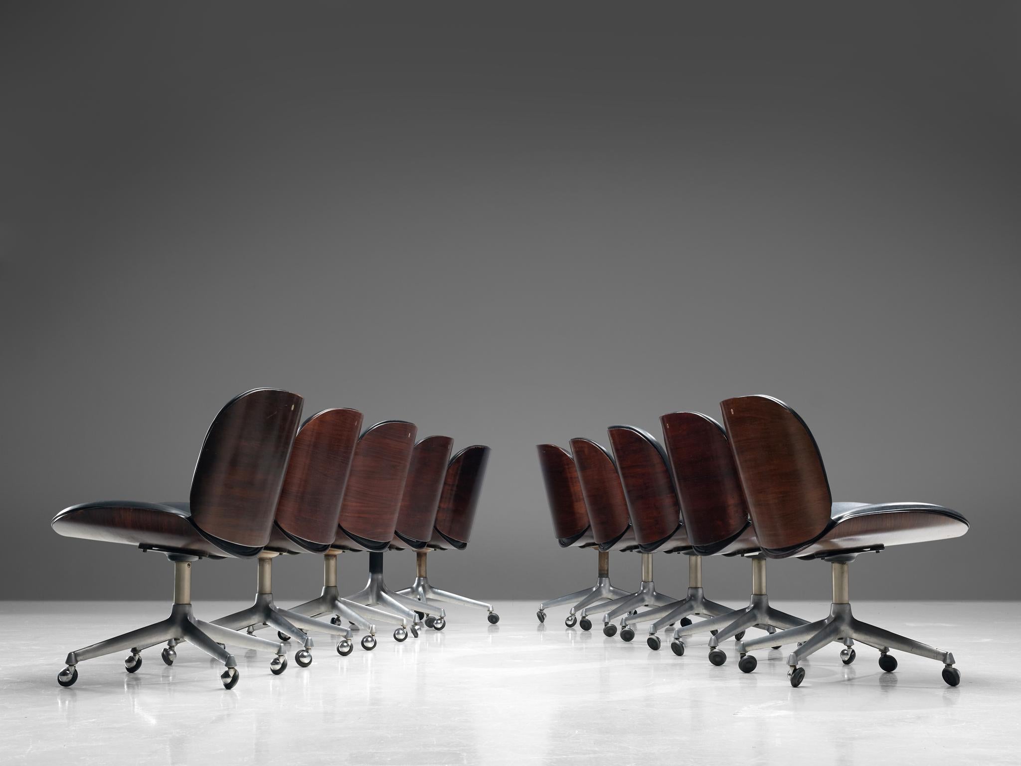 Ico Parisi for MIM Roma, set of 10 office chairs, rosewood, metal and leatherette, Italy, 1960s.

Swivel chairs from the 'Terni' series by MIM Roma. The seating and back consist of curved rosewood shells which hold the black leatherette cushions.