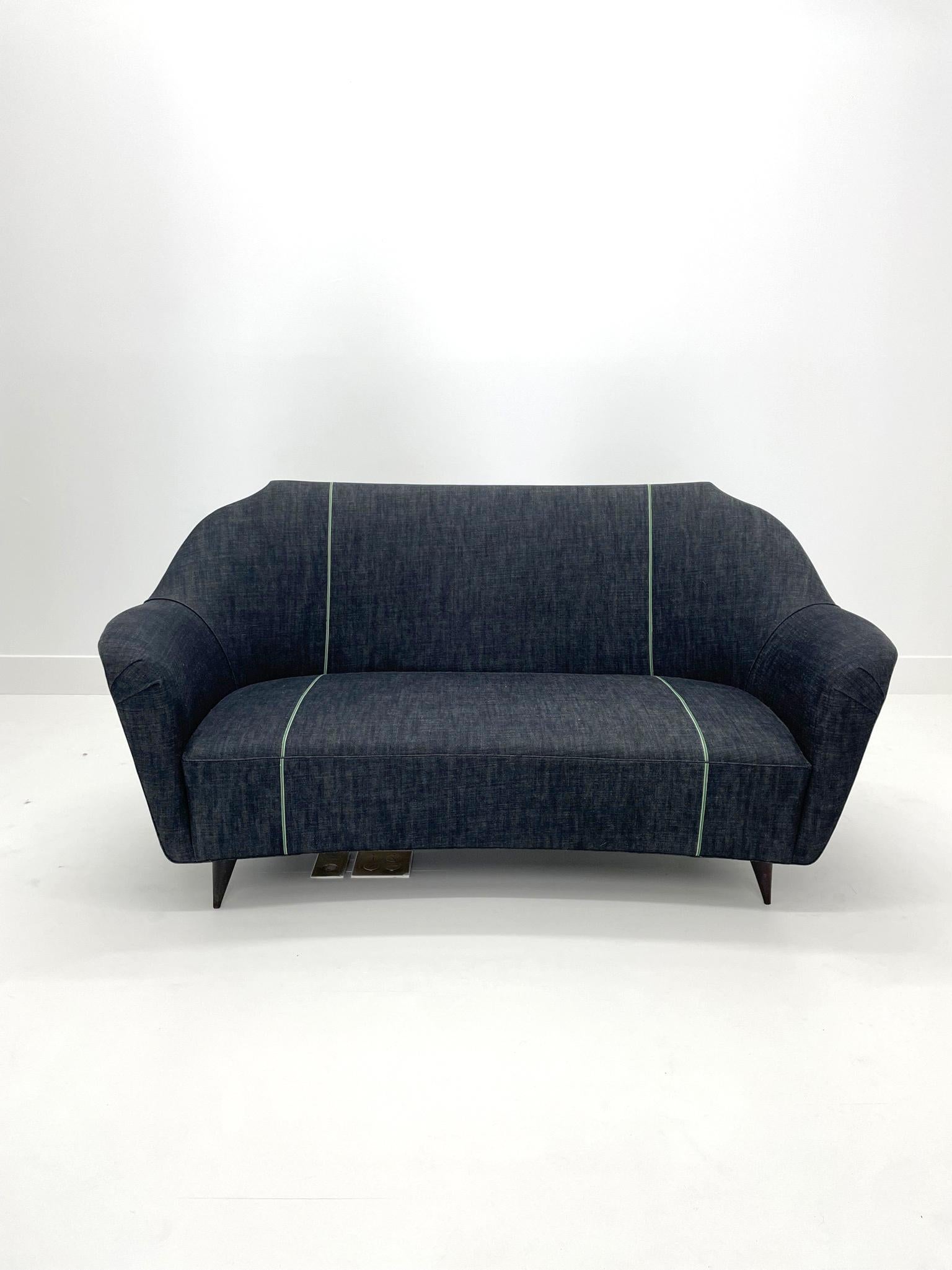 Settee by Ico Parisi, c. 1950. This tailored sculptural settee is as stylish as it is comfortable. Poised yet relaxed, the contours of this sofa are remarkably body conscious and naturally create a space for two people to sit at an angle to one