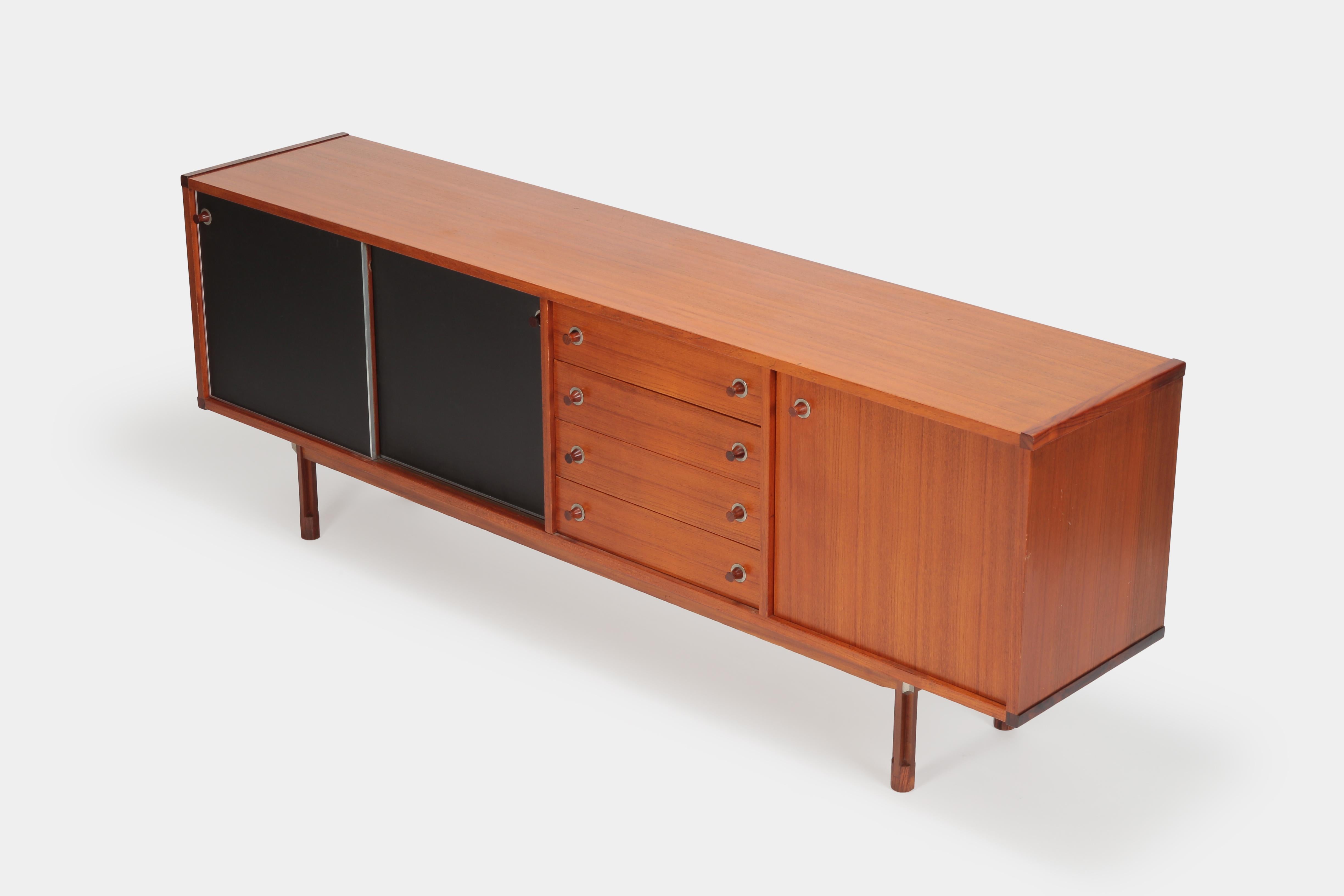 Ico Parisi sideboard manufactured by Stildomus in the 1960s in Italy. The frame and the front of the drawers are veneered with teak wood. Beautiful details like the edges and handles made of solid rosewood and the front of the sliding doors are