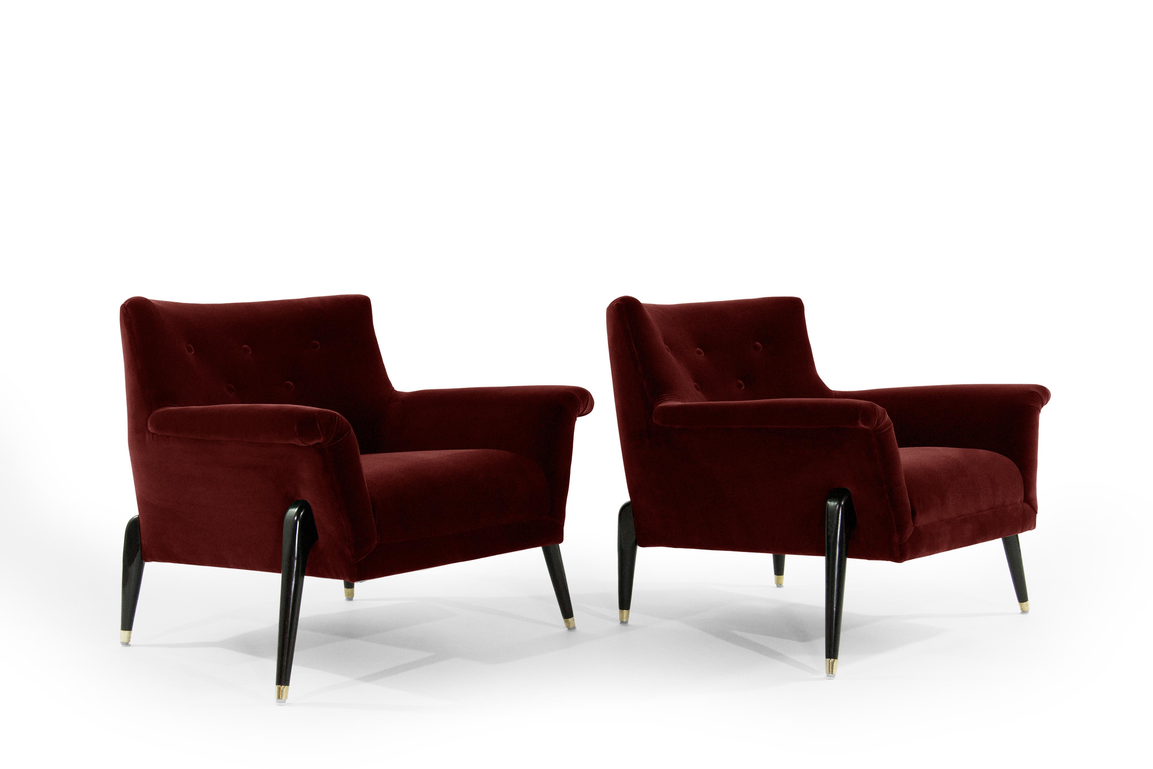 Pair of important Italian spider leg lounge chairs in the style of Ico Parisi or Jean Royére, all of the exposed wooden legs have been ebonized, brass sabots newly polished. Re-upholstered in a high-quality burgundy mohair.



  