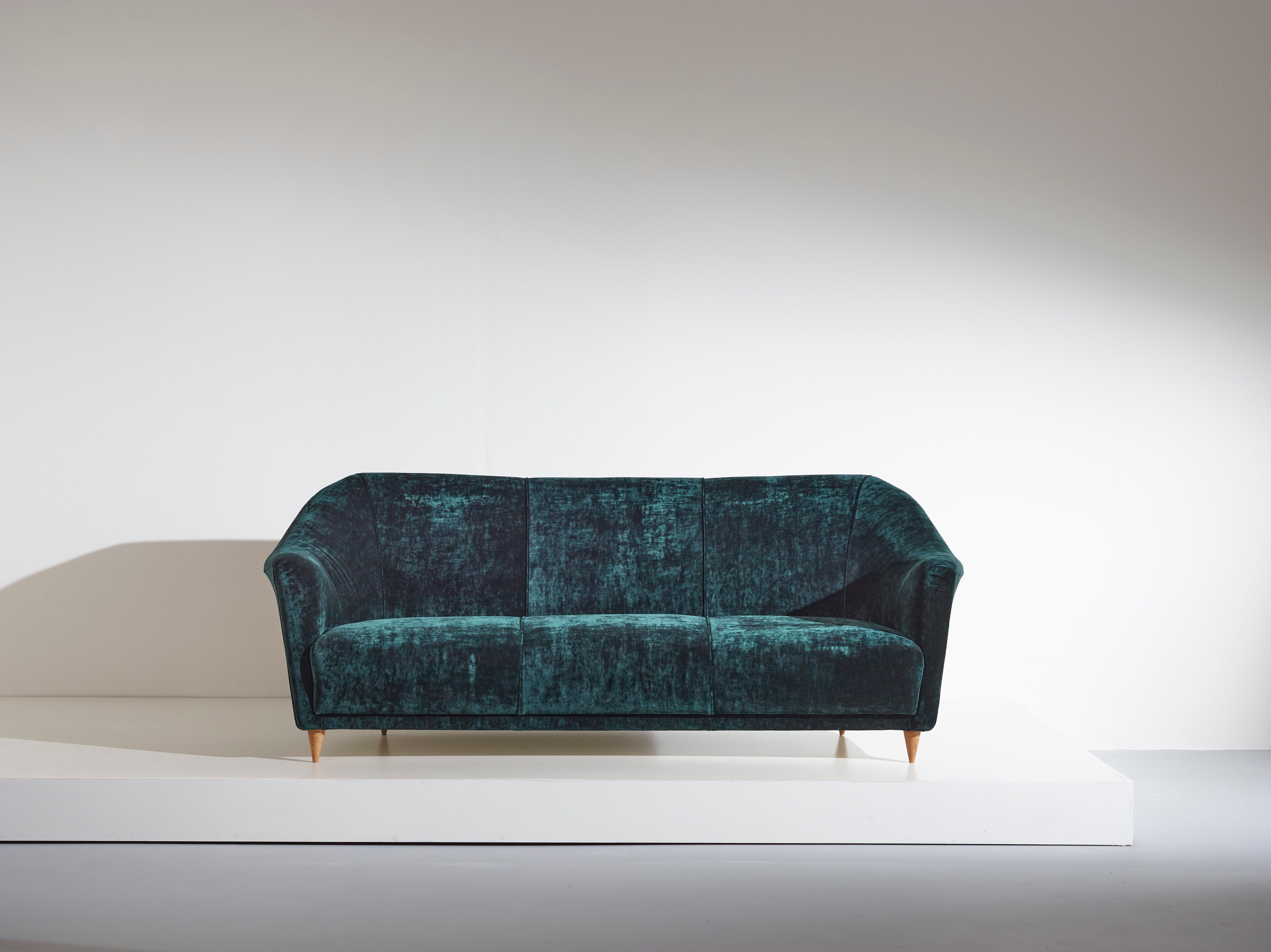 An extremely stylish and slightly curved three seater sofa attributed to Ico Parisi and made by Ariberto Colombo. It has been completely restored and reupholstered in a blue petroleum mottled velvet.

Dimensions: 100 x 210 x 86 cm