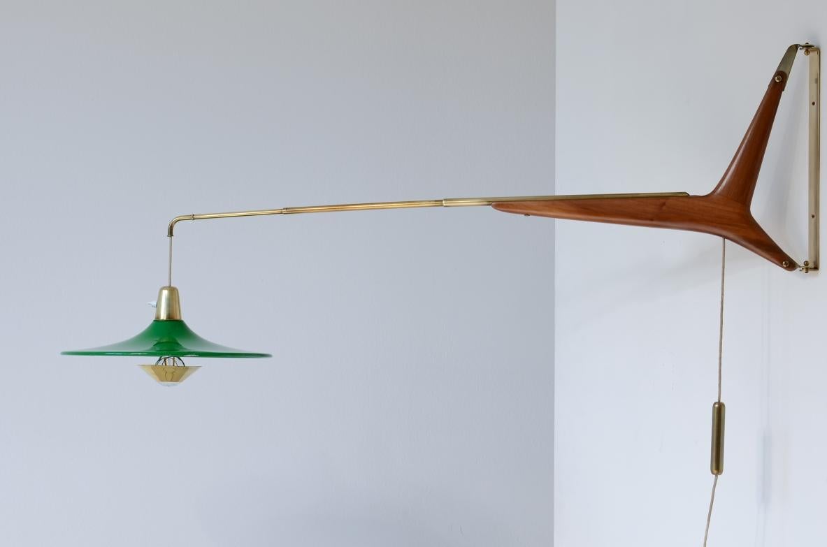 Ico Parisi (1916-1996)

Rare wall sconce lamp with extensible brass arm and cherry wood structure, lacquered metal hat.

Stilnovo manufacture, 1950s.

95/140x40 stem 40
