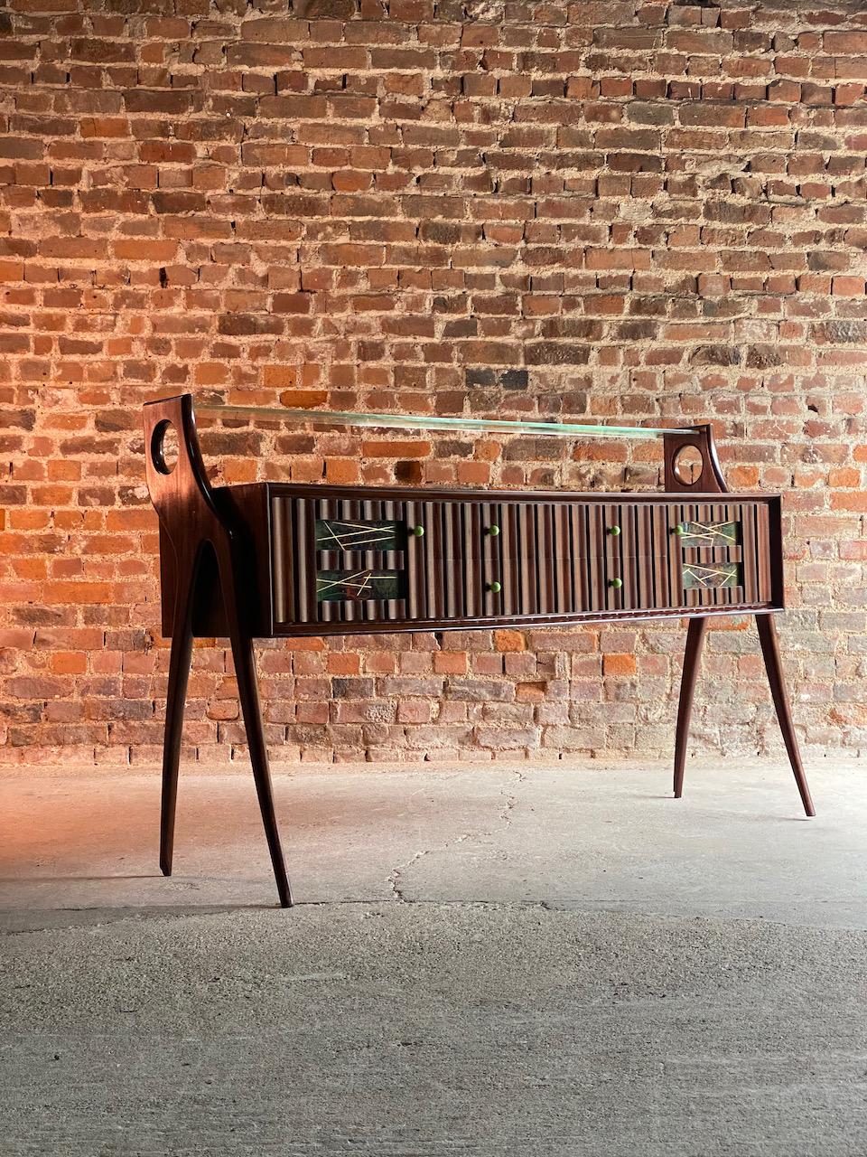 Ico Parisi walnut, Credenza, 1950

Sublime Italian Mid Century Modern Ico Parisi Walnut Credenza Italy circa 1950, the upper section with a clear glass shelf tenoned into stylised tall and elegant end legs, the suspended rectangular body with