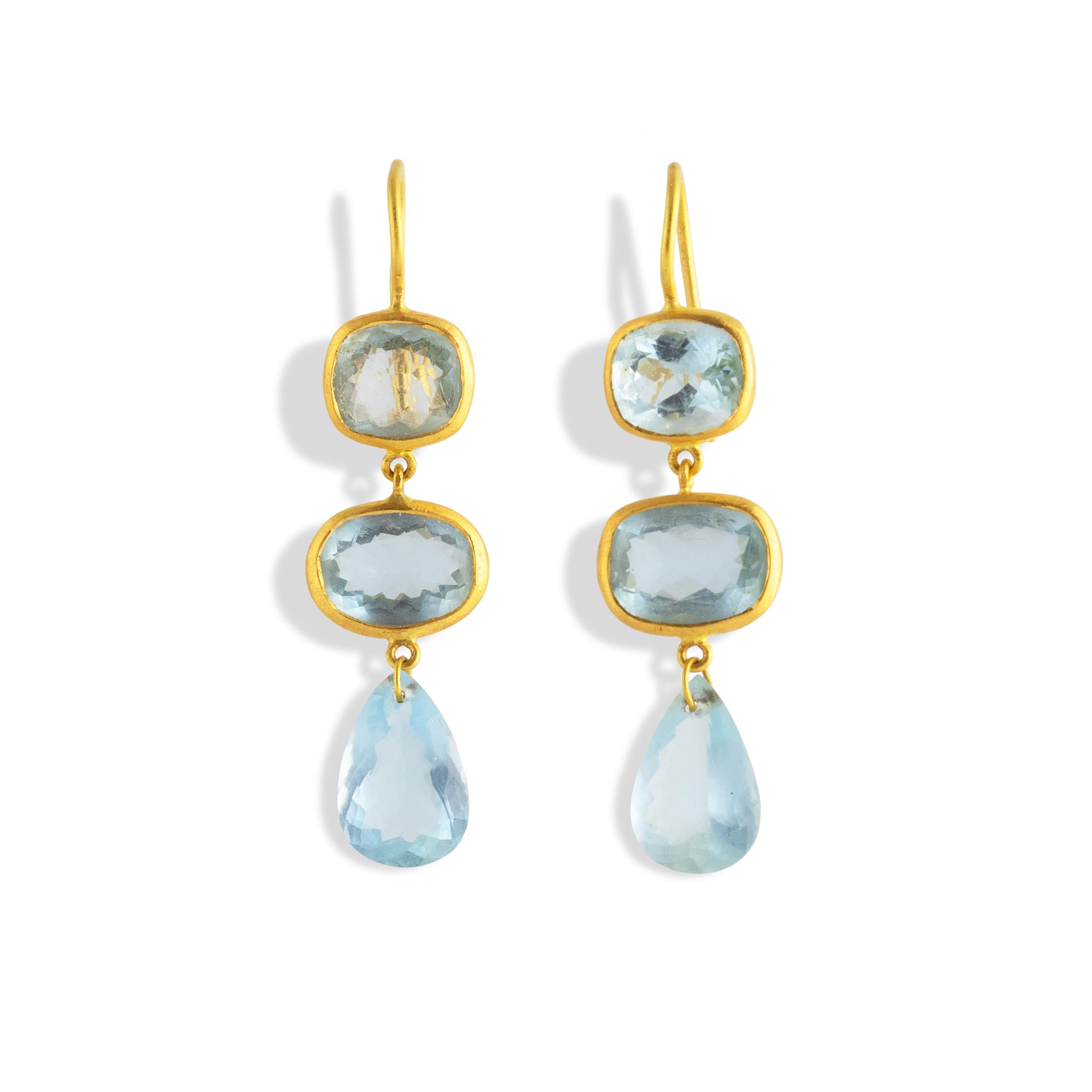 Rich blue Aquamarine 3 stone Earrings set in 22k.  Featuring cushion, oval, emerald and pear shaped gemstones, all in the shame shade of blue.   The richness of the gold highlights the saturated blue of these aquamarines.

According to legend,