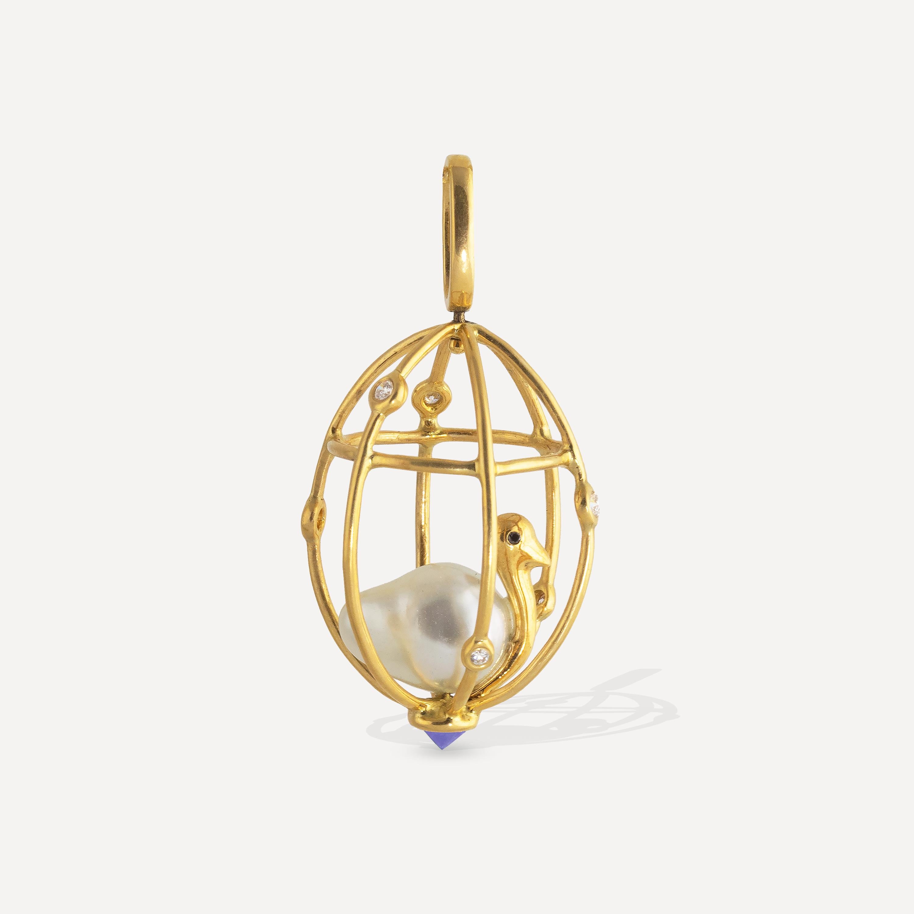 Perched inside this 18k diamond studded cage is a delicate bird; its body made from a 12mm x 9mm Baroque pearl, black diamond eyes decorating its golden body. The pendant features a reverse set .30 carat tanzanite  at the bottom of the cage and