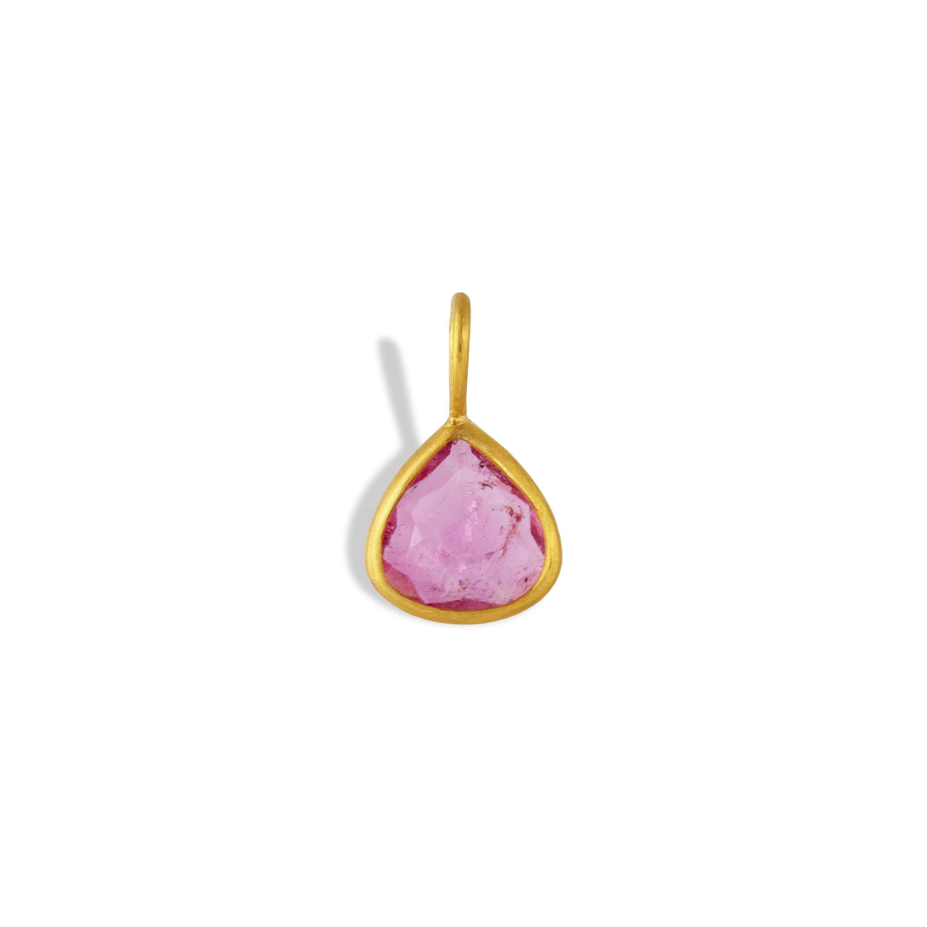 This amazing piece features a pear shaped Pink Tourmaline gemstone measuring 16mm x 9mm and weighing 2.29 carats. This pendant is set in 22k gold and made by hand in our workshop in Jaipur, India.


Tourmaline is known to aid in relieving stress and