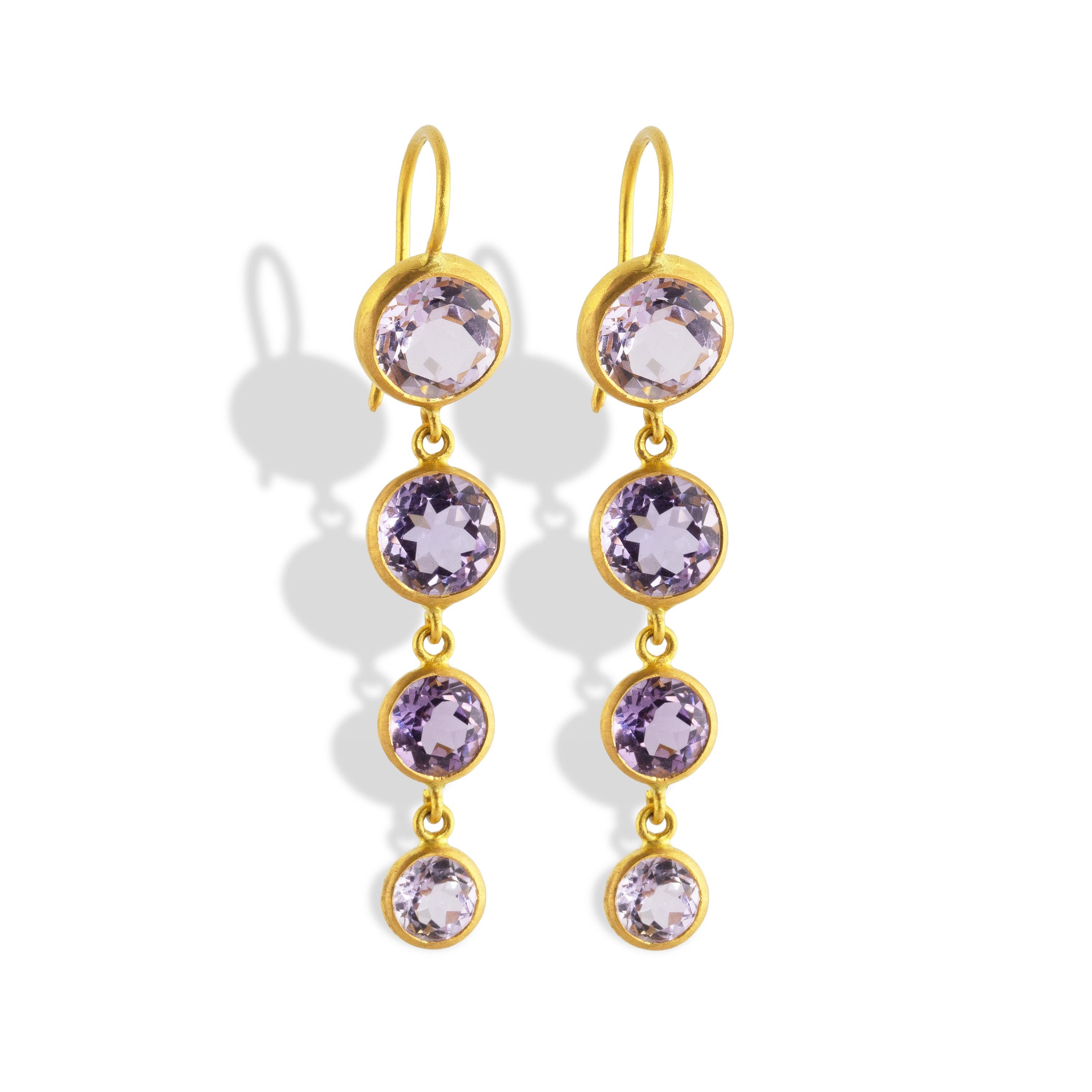 These one of a kind, sparkling earrings feature 8.14 carats of Brazilian Amethyst faceted round gemstones set in 22k Matte Yellow Gold.  A delicate drop of four drops highlight the soft violet color of the gems.  

Amethyst served royalty throughout