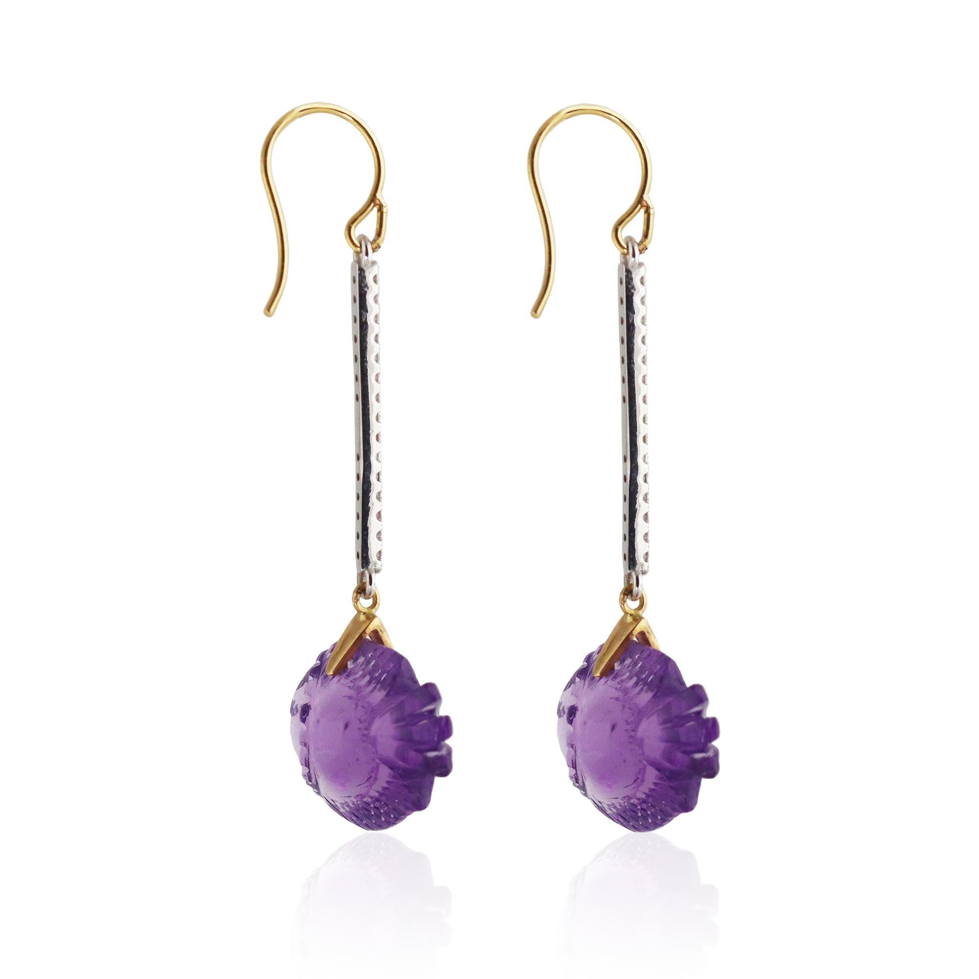  Amethyst hand carved fish decorate Diamond stick drops.  The Amethyst fish is carved in beautiful Brazilian Amethyst in a deep, rich hue.  The earrings are whimsical and glamorous all in one.  
One of a kind.

Amethyst served royalty throughout