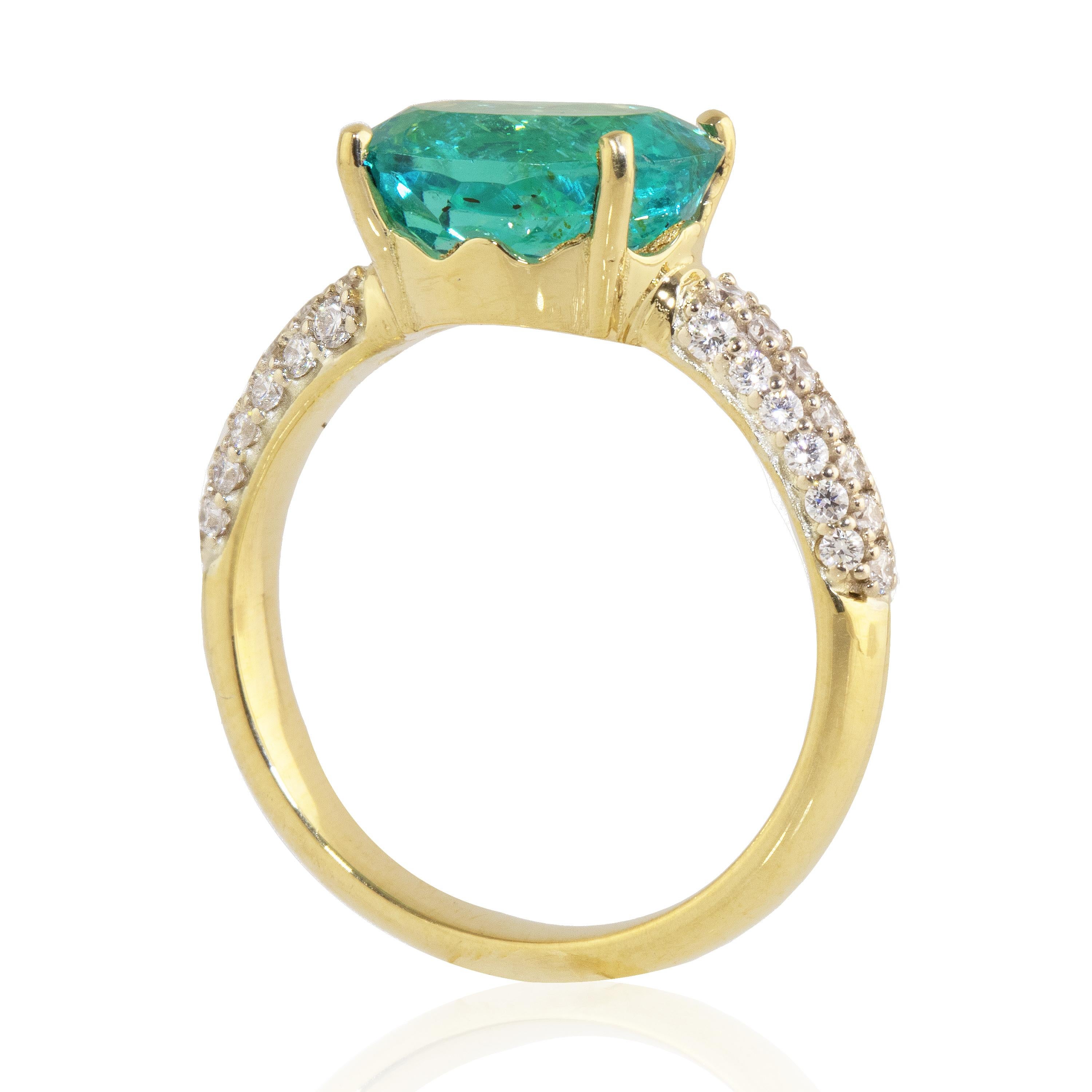 Featuring a super bright, Apatite center stone atop a wave bezel with pave diamonds (.31 carats) along the band.  This ring was inspired by the colors of the deep  ocean waves.  Featuring a 2.95 carat bright Apatite at the center.  

Apatite is a