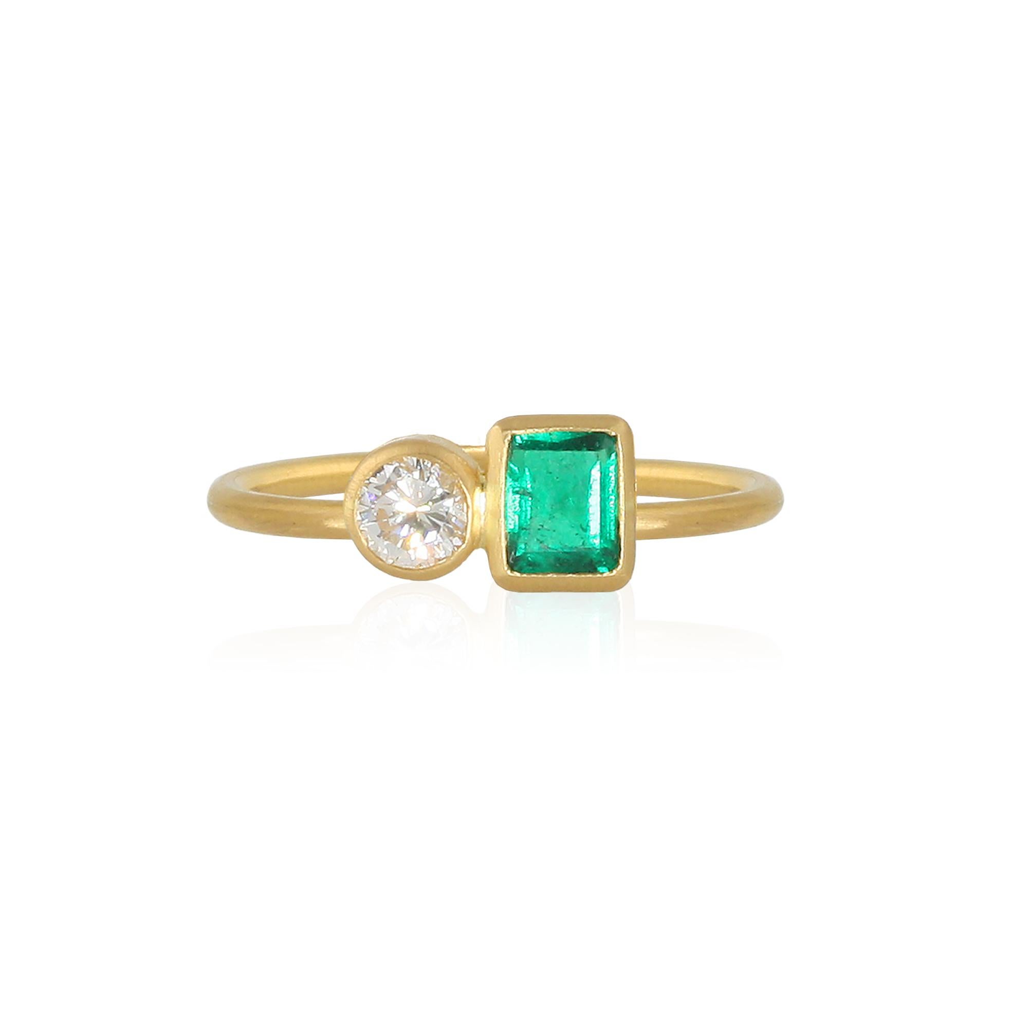Gorgeous stacking ring featuring a square .45 carat Vivid Green AAAA Columbian Emerald and a .25 carat White VS round Diamond set side by side.  Finished with a round 1.5mm band.  

In ancient times diamonds were believed to be fragments of stars
