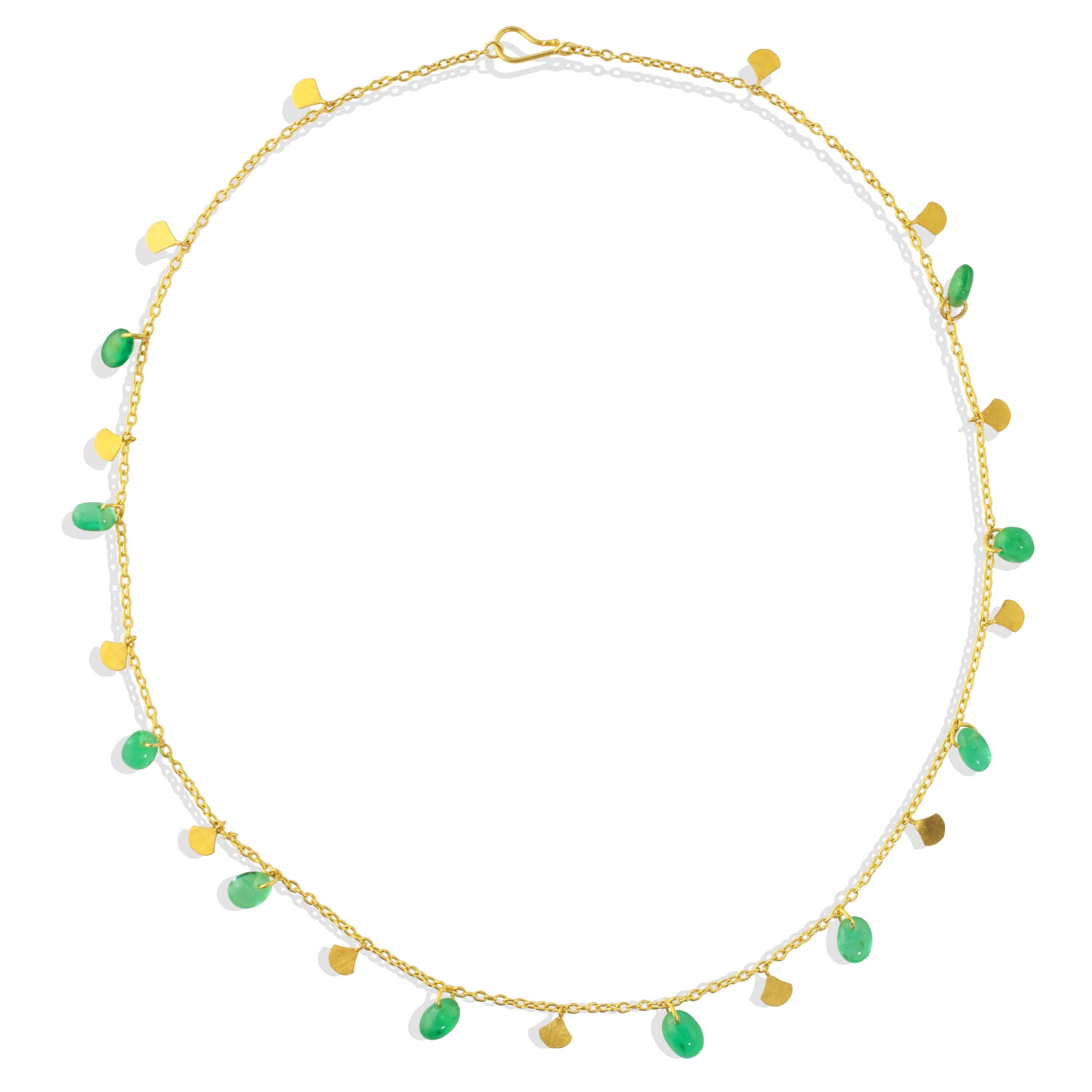 A charming, delicate necklace featuring Emerald pebbles  and matching 22k gold sequin charms.   Featuring 12.5carats of Columbian Emeralds  (approx. 8mm x 6mm) and matching gold sequins that decorate a 22k gold chain with a hook closure.  16.5