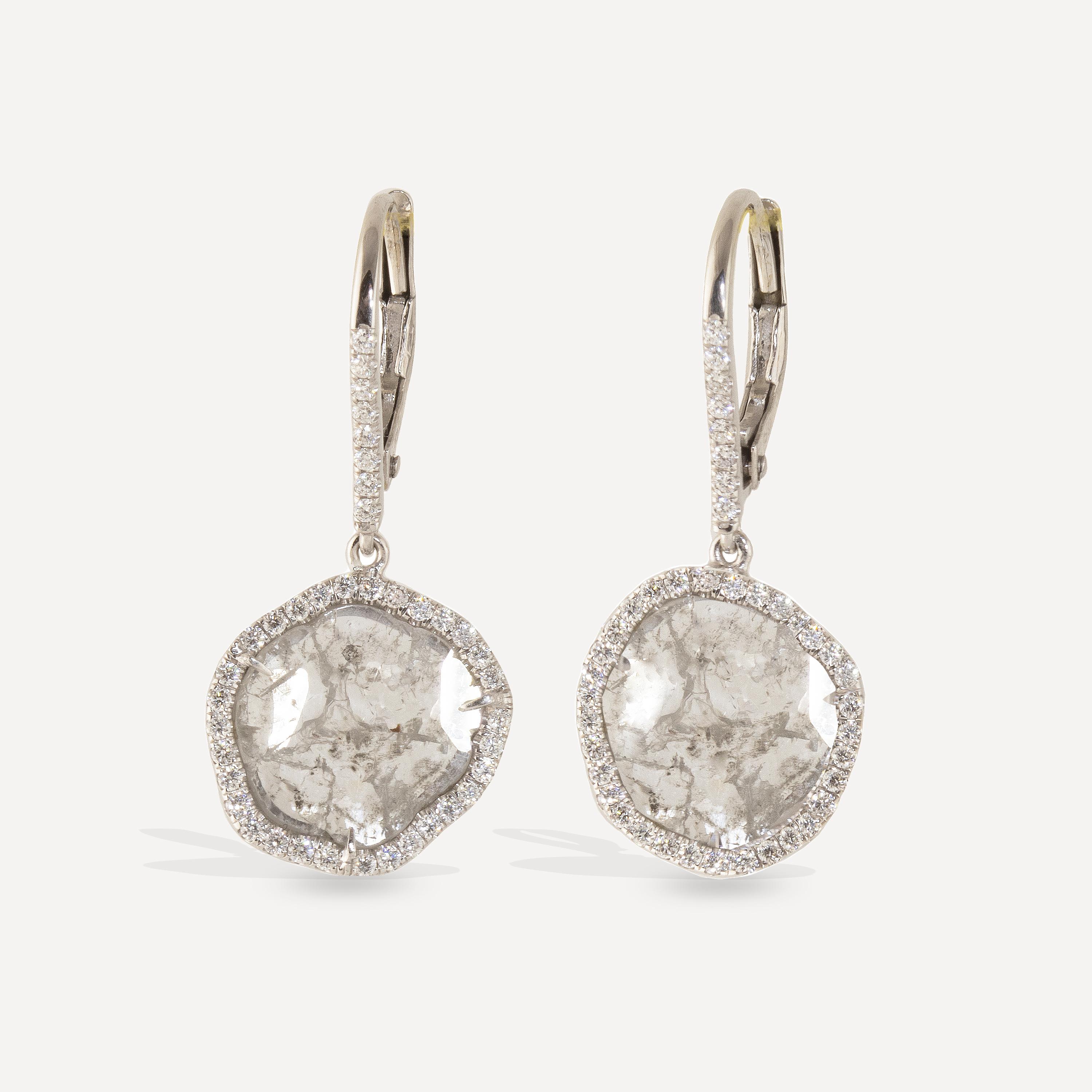 Exquisite 3.4 carat diamond slices earrings featuring a halo of .95 carats of Brilliant Diamond Pave. Set in 18k white gold with lever backs, these spectacular earrings were made by one of our master craftsman entirely by hand, using ethically