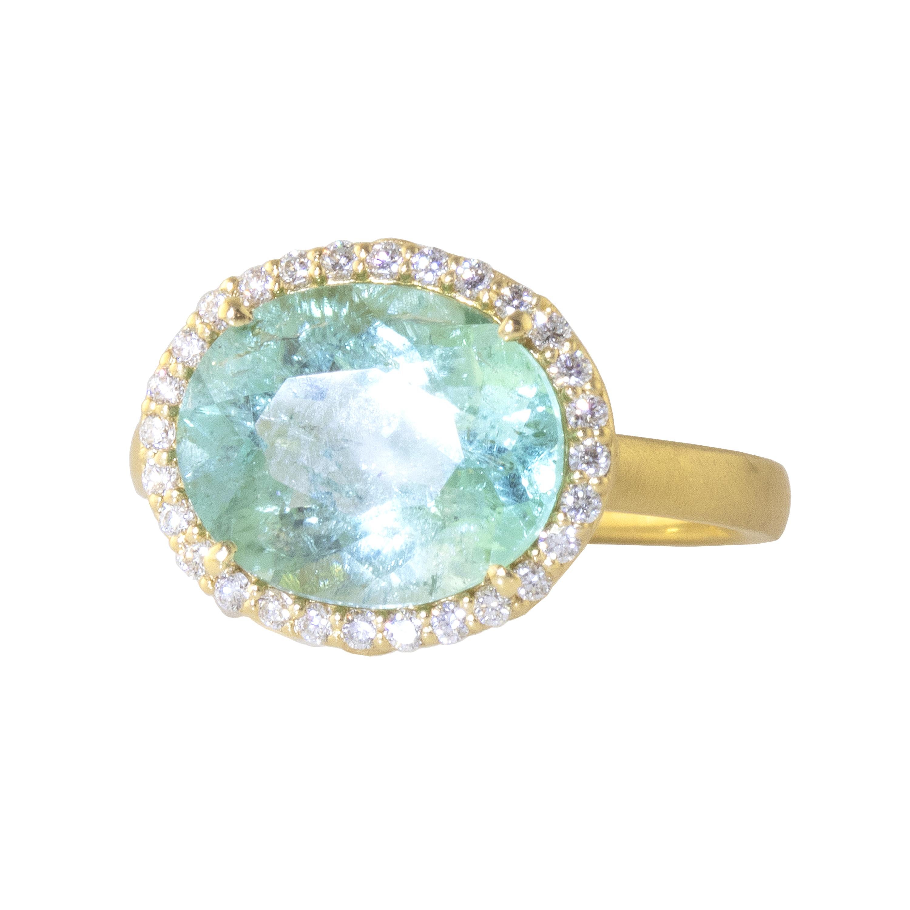 Dreaming ring featuring a 4.29 carat Mint Green, Paraiba colored tourmaline set in an 18k gold  wave bezel decorated with diamonds. The color of this tourmaline is a soft, mint color, similar to the color in Paraiba tourmalines.  Diamonds decorate