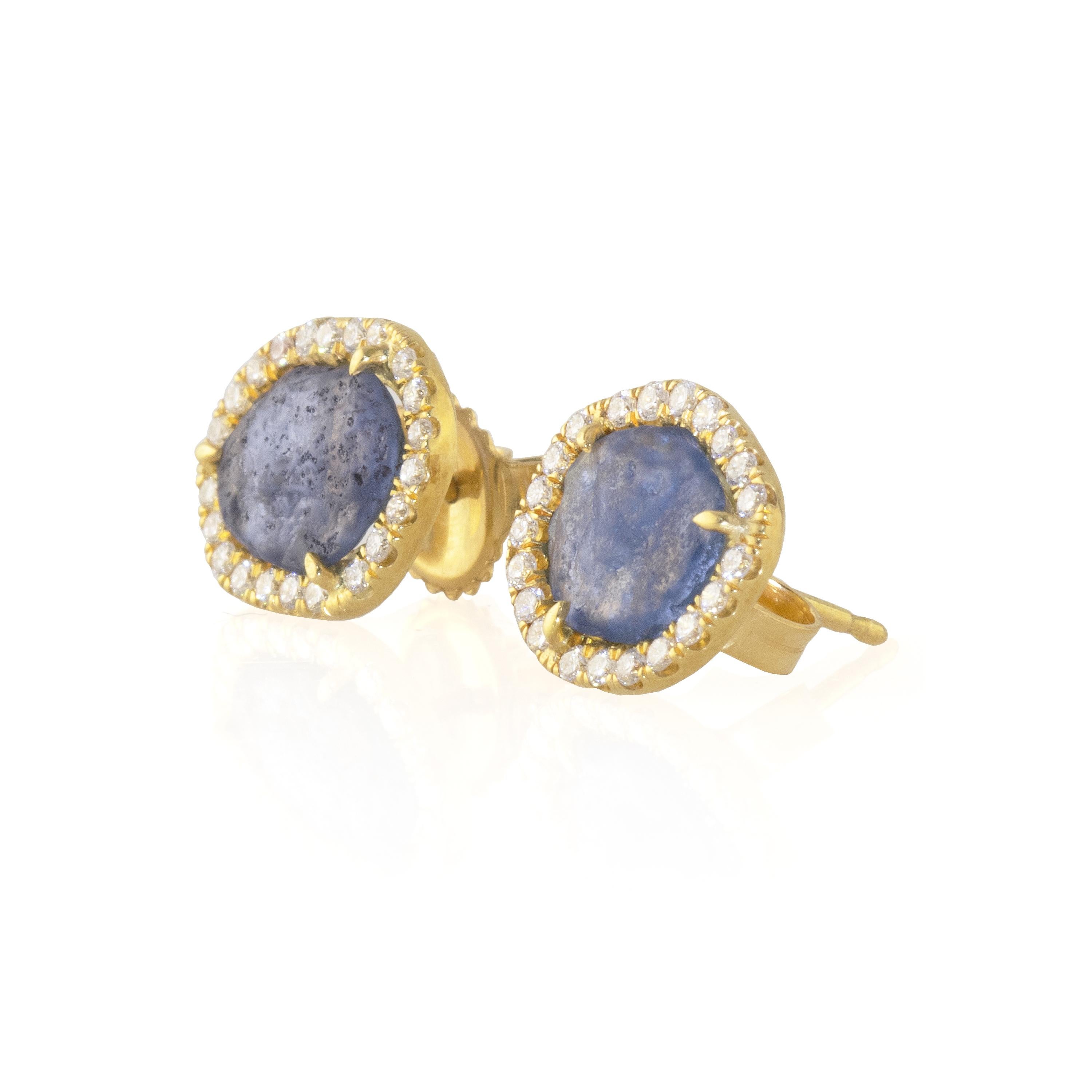 These beautiful studs feature a flat Montana Yogo Sapphires rough stone surrounded by VS diamonds (.38cts). Yogo Sapphires are considered to be among the finest sapphires in the world and are the most precious found in North America. These are