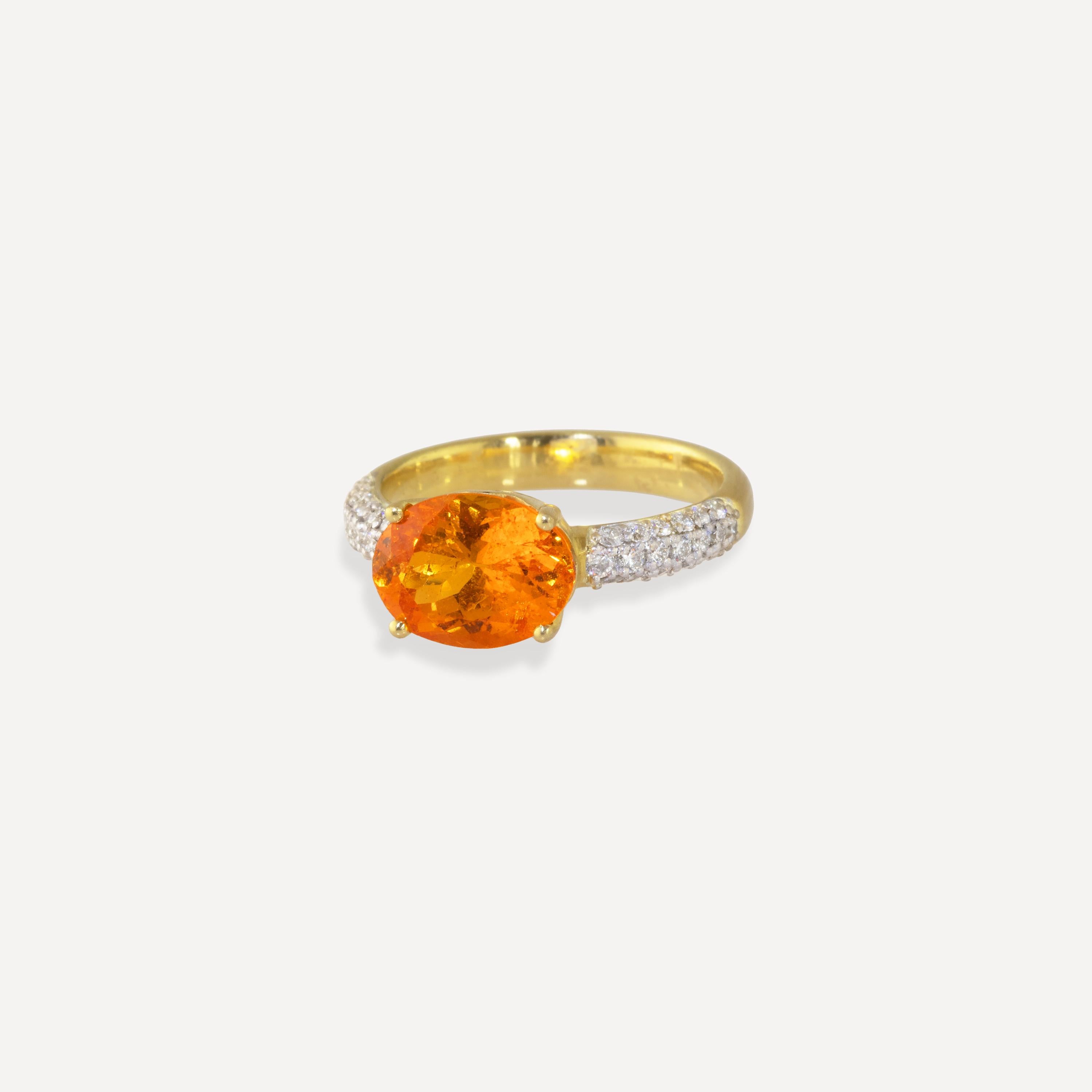 This ring features a super bright, Fanta Orange Spessartite Garnet center stone atop a wave bezel with pave diamonds (.31 carats) along the band.  This ring was inspired by the reflections of the sun on ocean waves.  Featuring a 3.97 carat bright